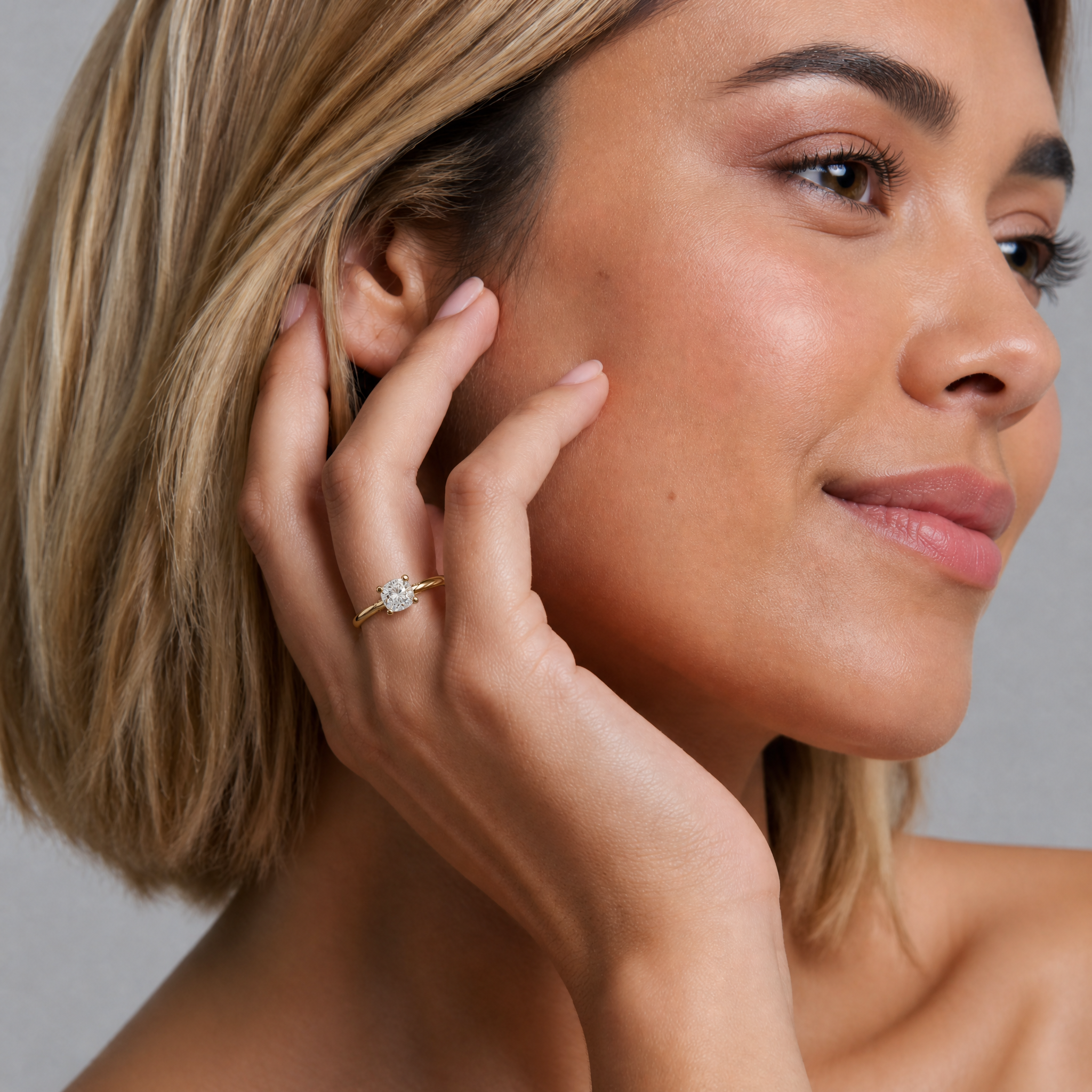 Brand ambassador Sofia Valerius for Raul Diamonds, elegantly modeling a high-clarity cushion cut diamond engagement ring that captures the light with every movement