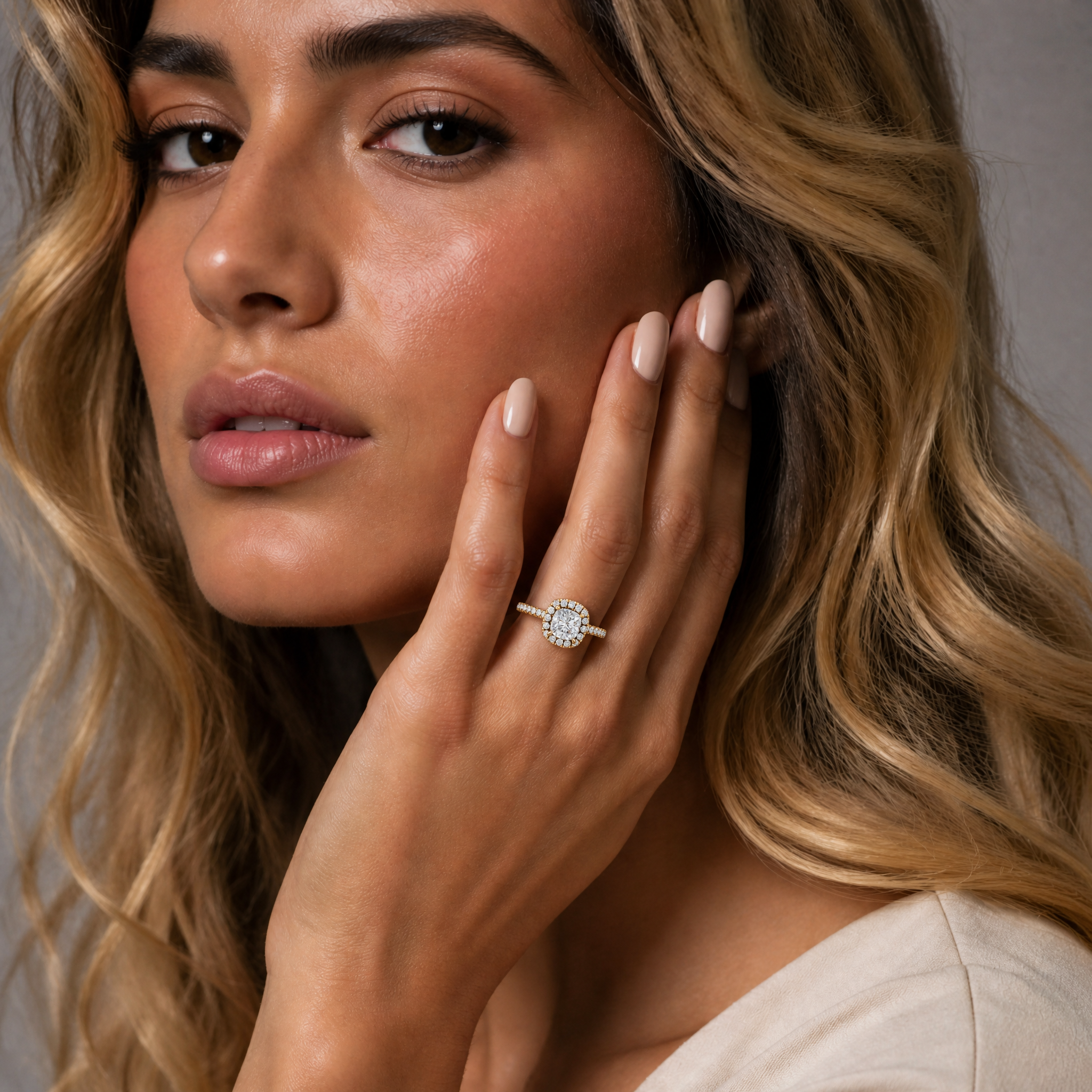 Sophia Rossi elegantly modeling a Raul Diamonds handcrafted cushion cut halo engagement ring to showcase the brilliant fire and luxury finish.