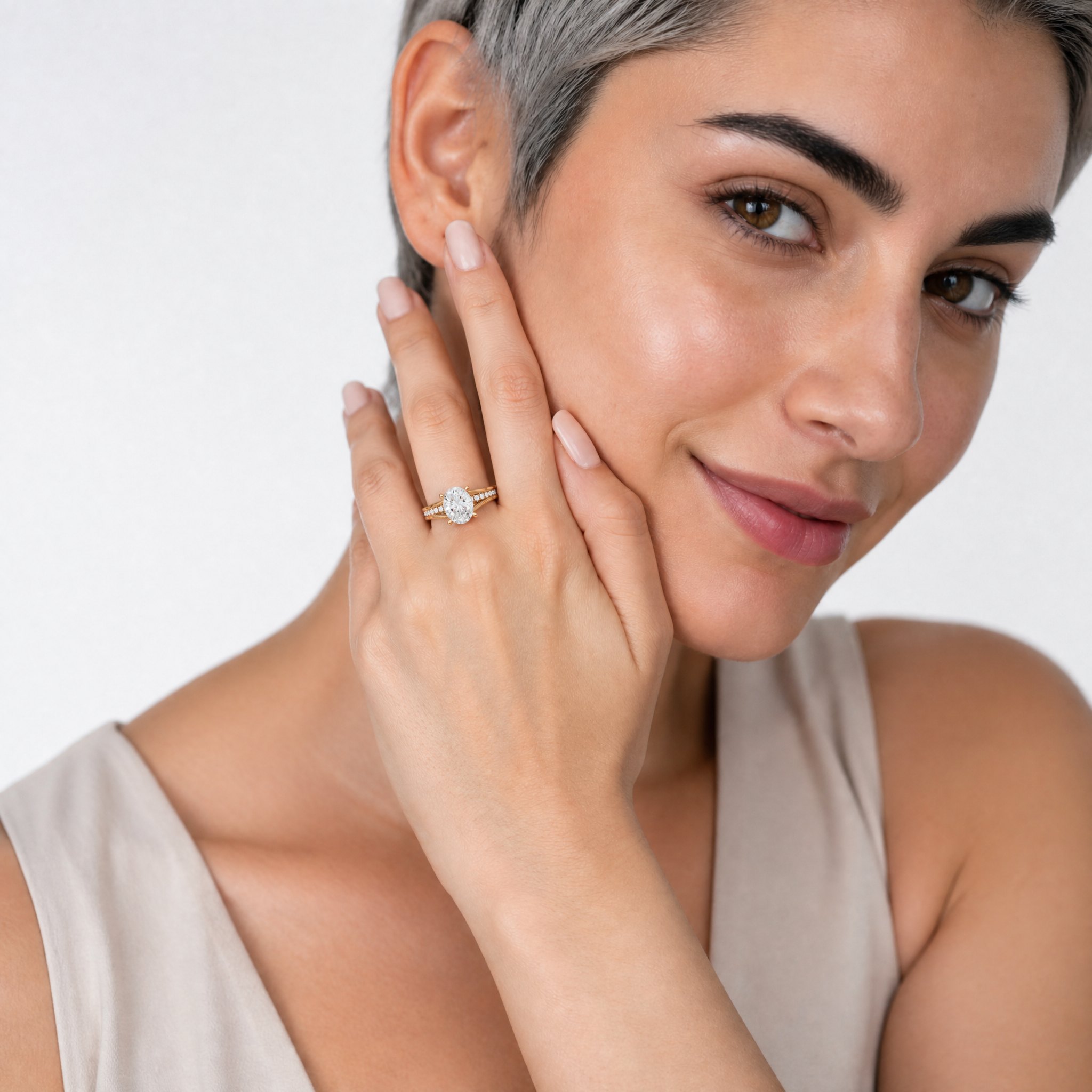 Elegant Model Wearing Oval Cut Lab Grown Diamond Engagement Ring in 14K Yellow Gold – Raul Diamonds