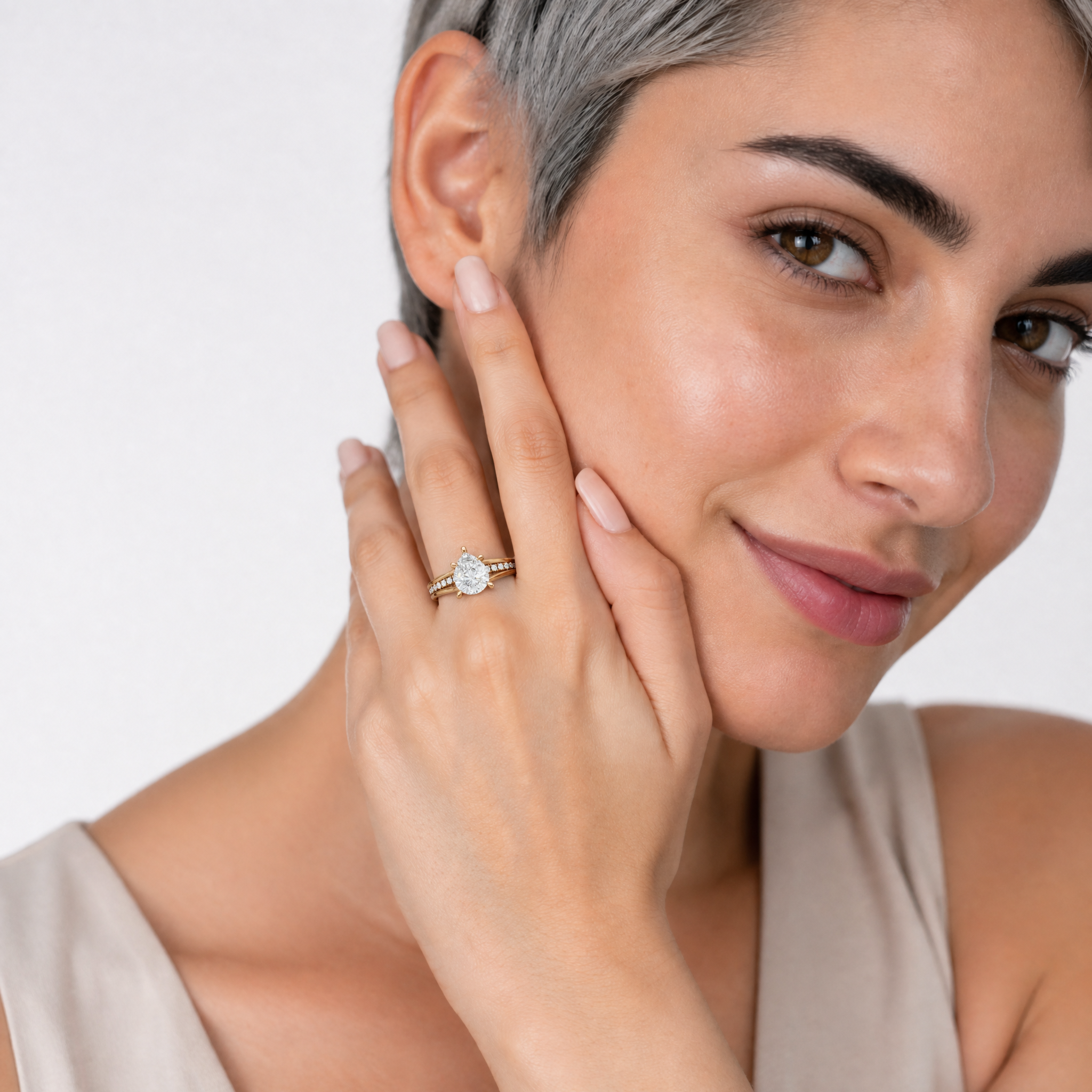 Elegant Model Wearing Pear Cut Lab Grown Diamond Engagement Ring in 14K Yellow Gold – Raul Diamonds