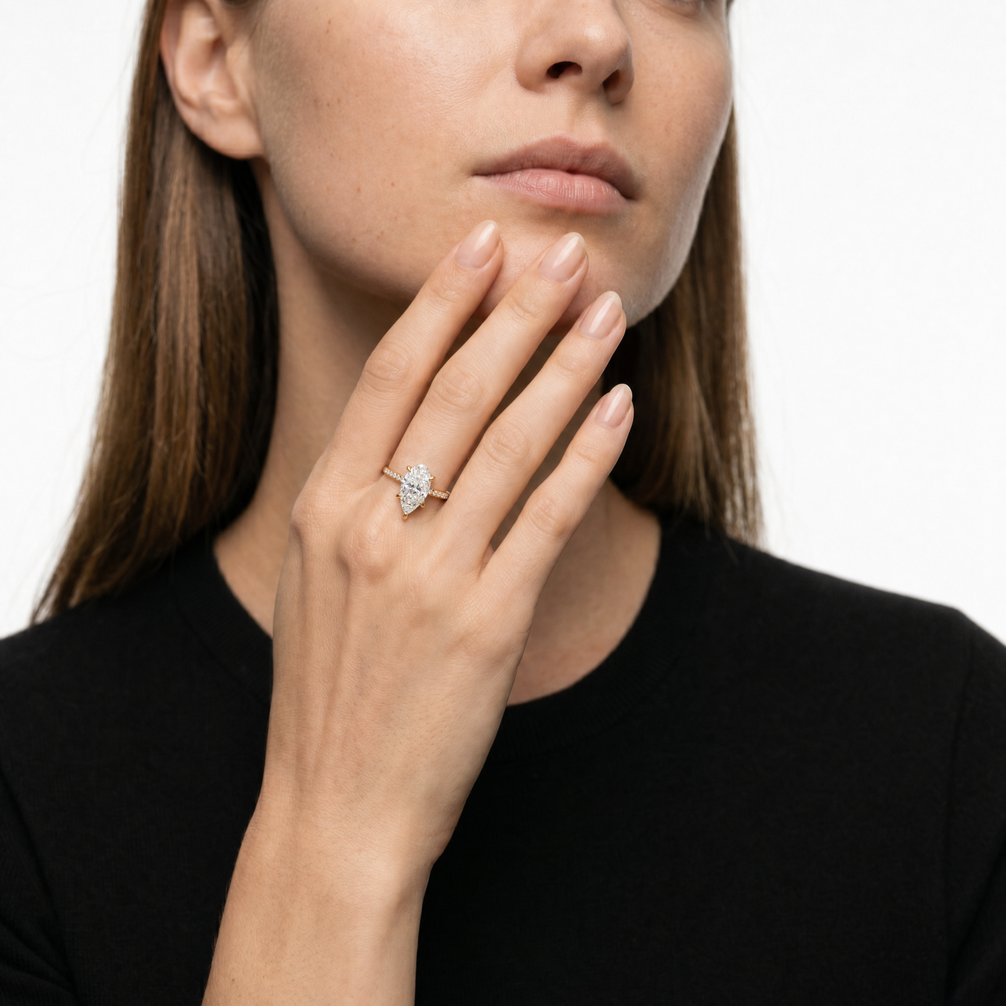 Elegant Model Wearing Pear Cut Lab Grown Diamond Engagement Ring in 14K Yellow Gold – Raul Diamonds