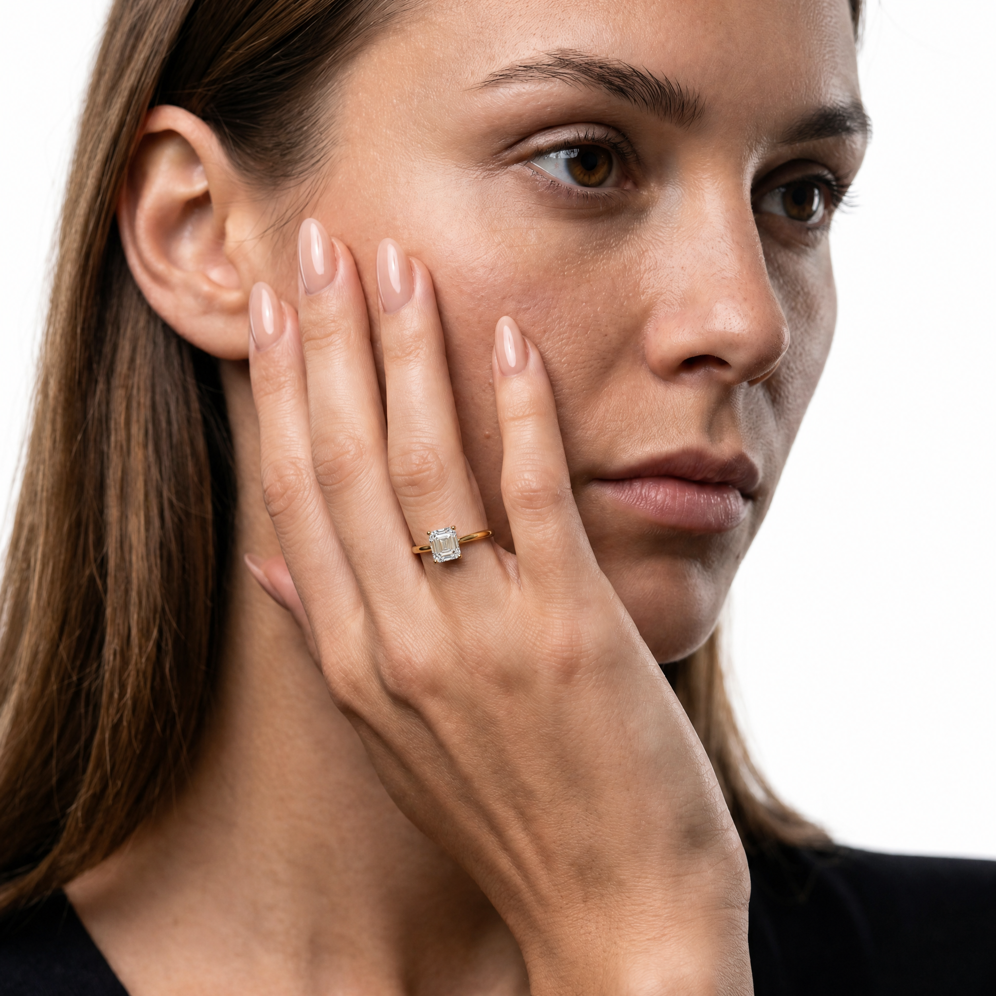 Elegant model wearing Raul Diamonds Aria Asscher cut engagement ring in 18k gold