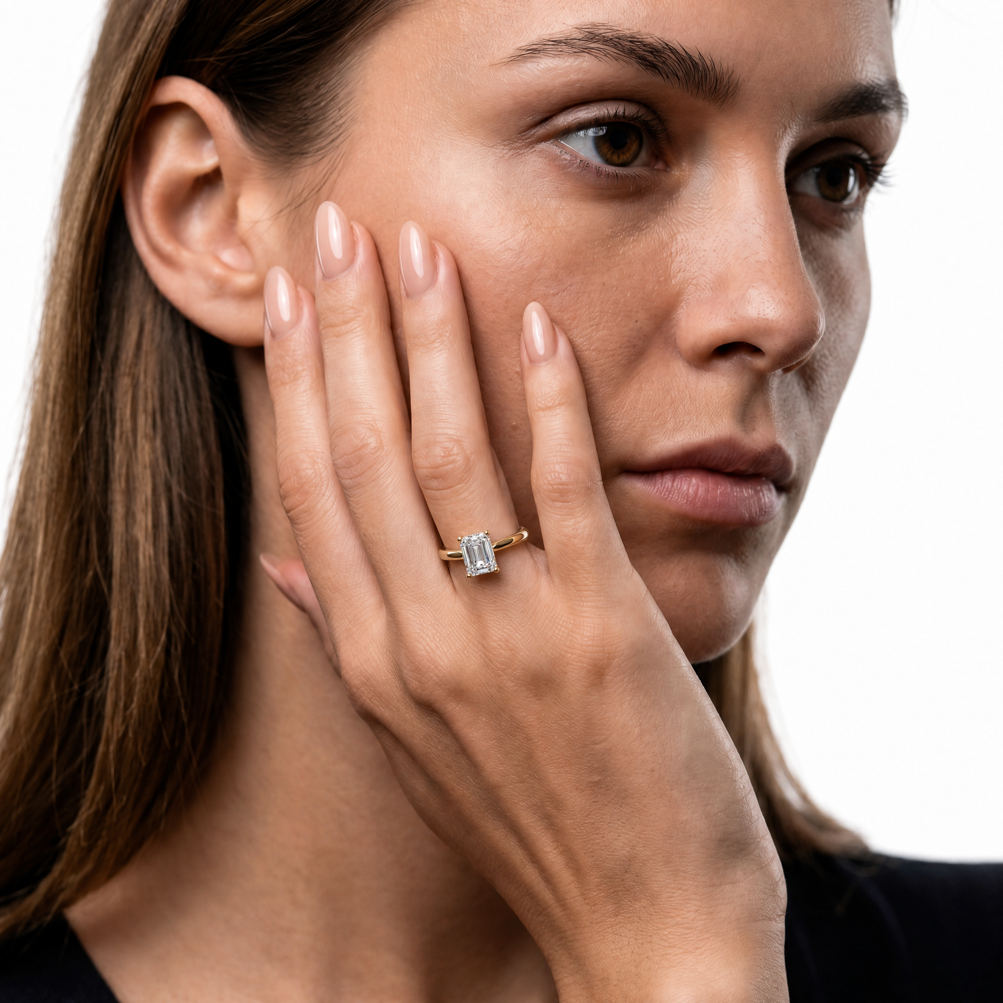Sophisticated model showcasing the Raul Diamonds Celine emerald cut engagement ring in 14k rose gold
