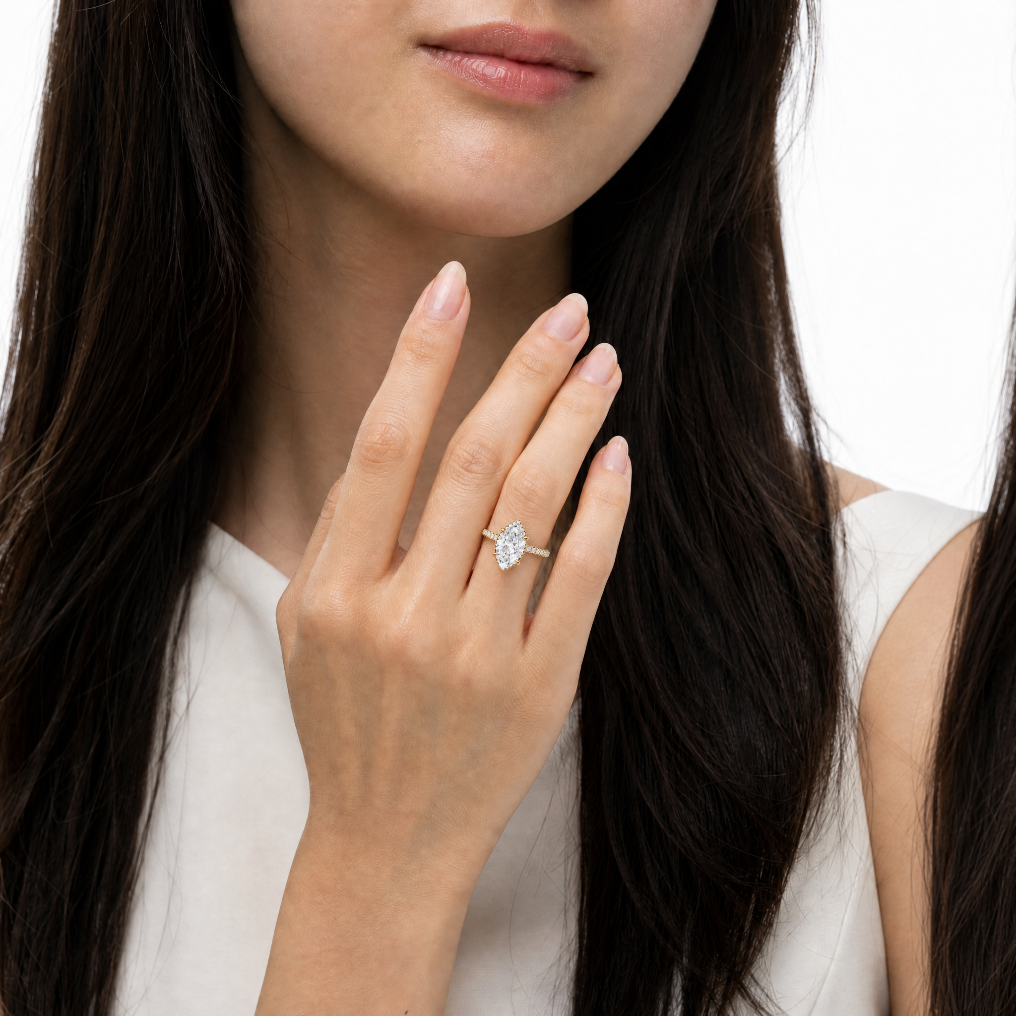 The Isabella model showcasing a Raul Diamonds Marquise Cut Hidden Halo engagement ring, highlighting the elegant elongated shape and the brilliant pavé diamond band
