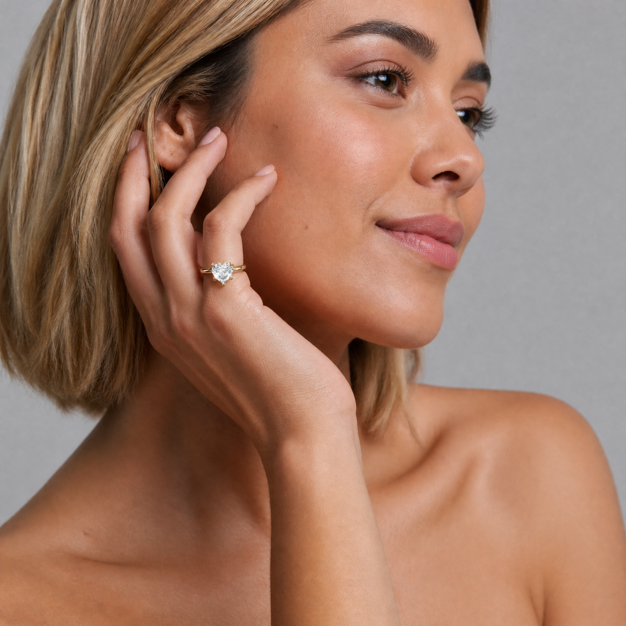 Luxury model Valentina Rossi posing with a Raul Diamonds heart-shaped engagement ring, capturing the romantic essence and brilliant sparkle of the fancy-cut diamond.
