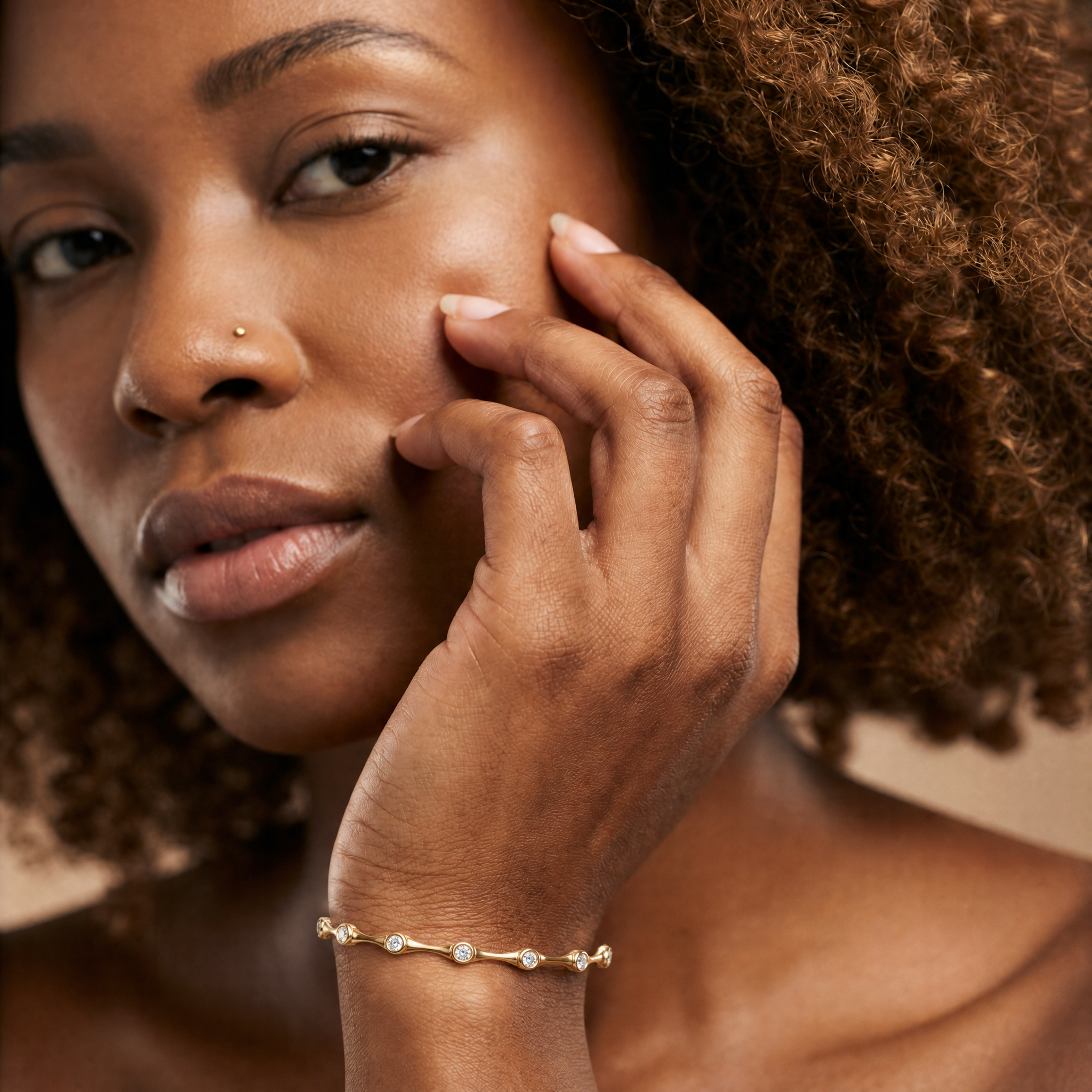 Elegant female model wearing a minimalist lab grown diamond bracelet in yellow gold by Raul Diamonds featuring modern fine jewelry craftsmanship and timeless luxury style