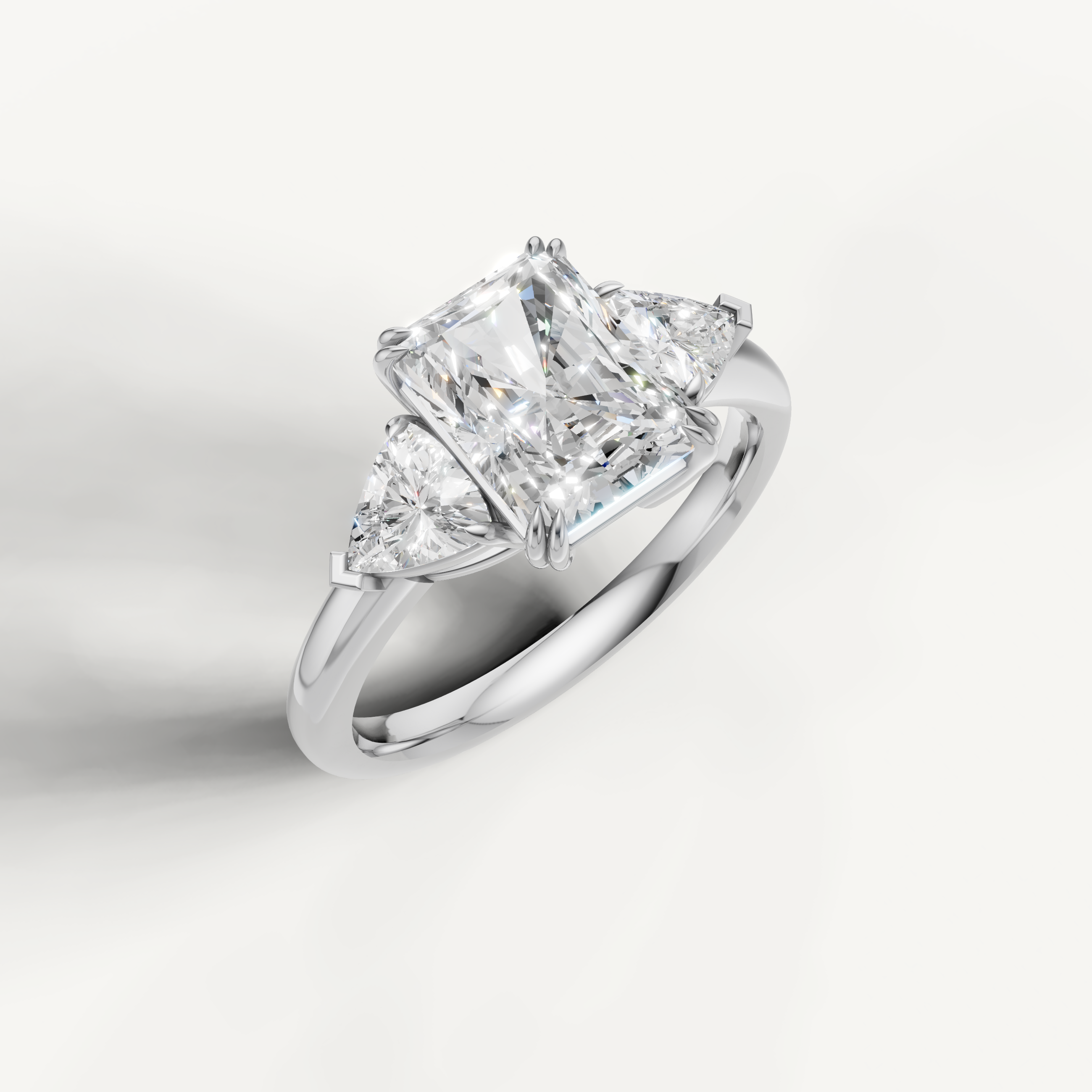 luxurious radiant cut lab grown diamond trilogy ring with brilliant trillion side accents