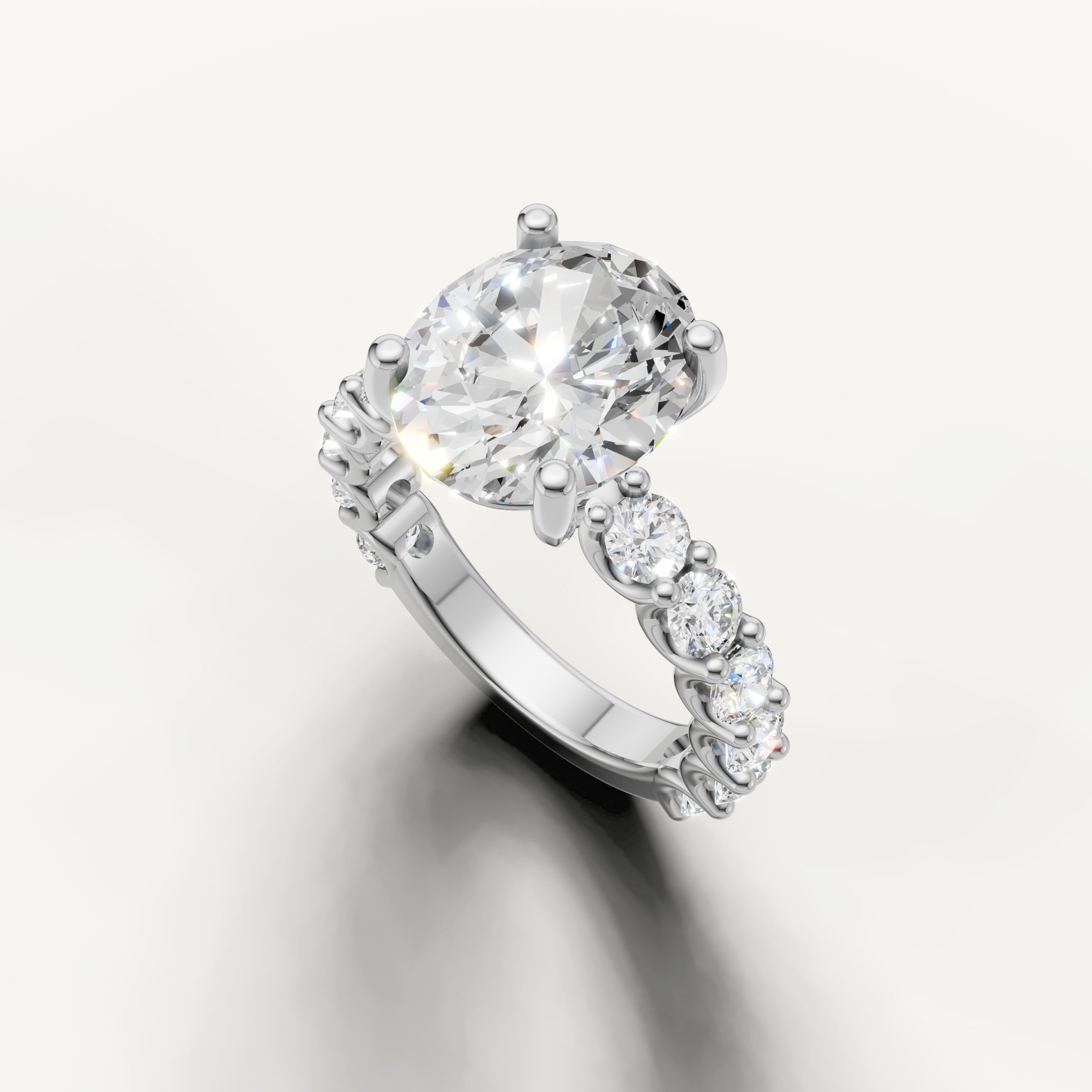 Oval cut diamond ring with graduated side stones shared prong setting white gold