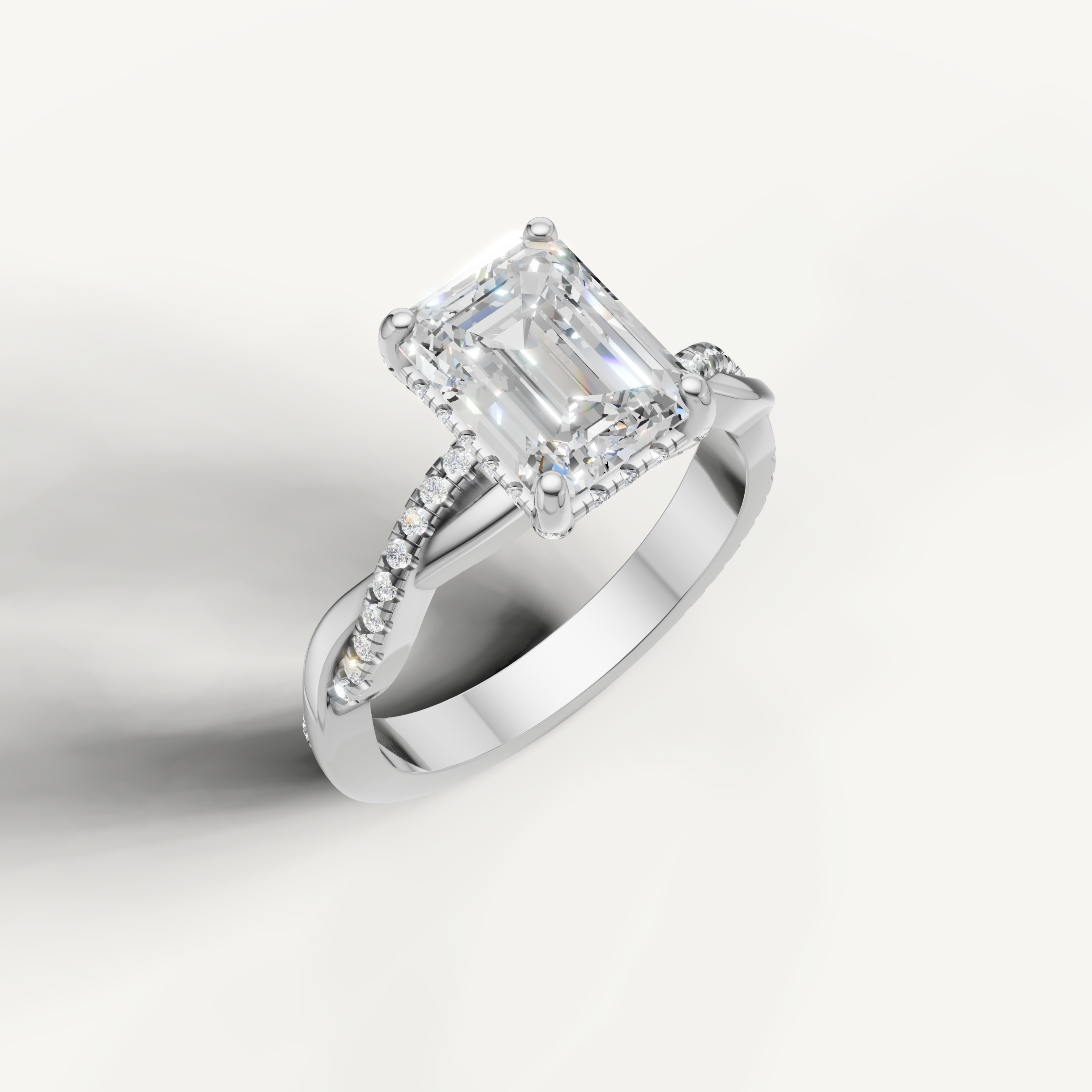 Sophisticated white gold emerald cut solitaire ring with a modern twisted design, available at Raul Diamonds