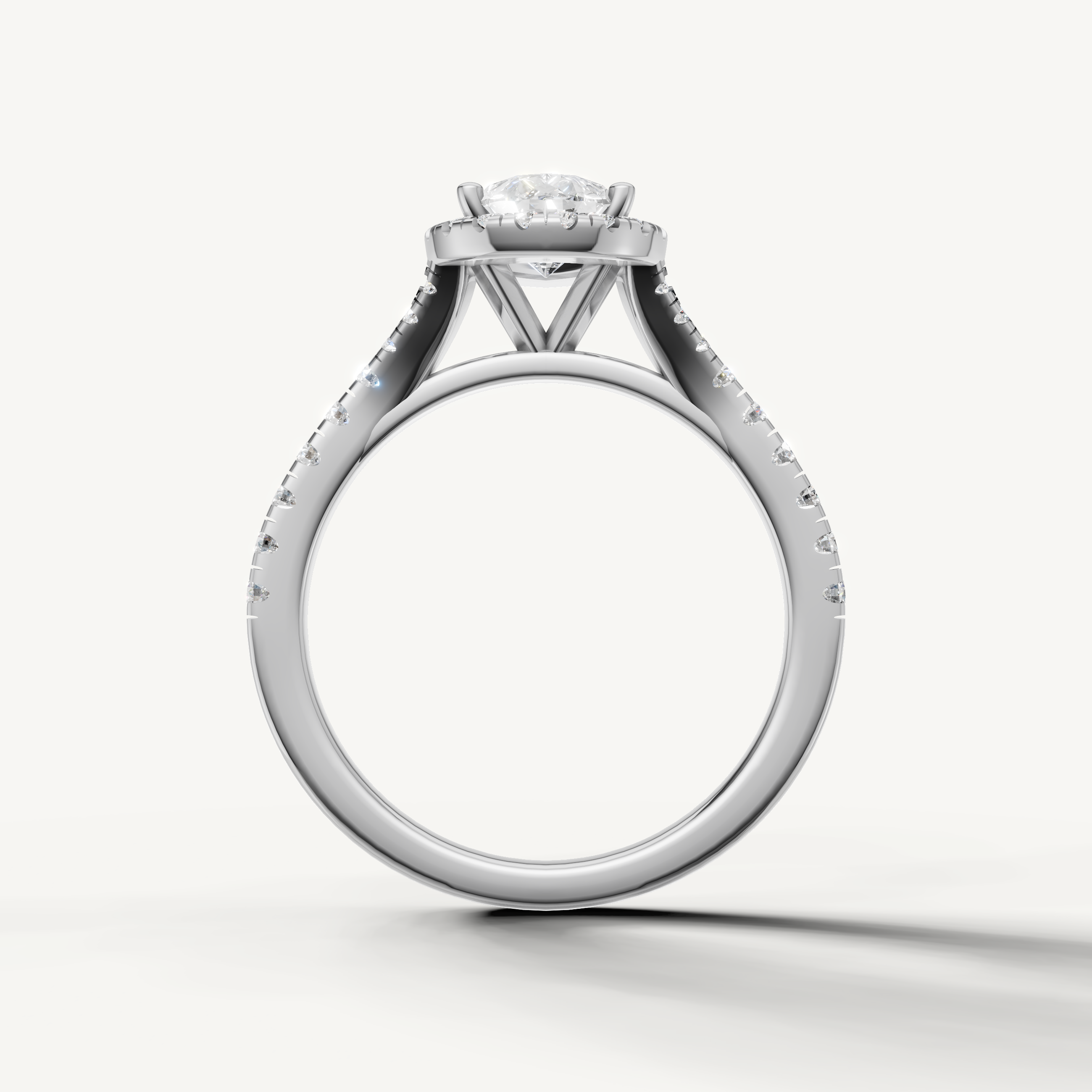 Pear cut engagement ring with halo and pavé band white gold