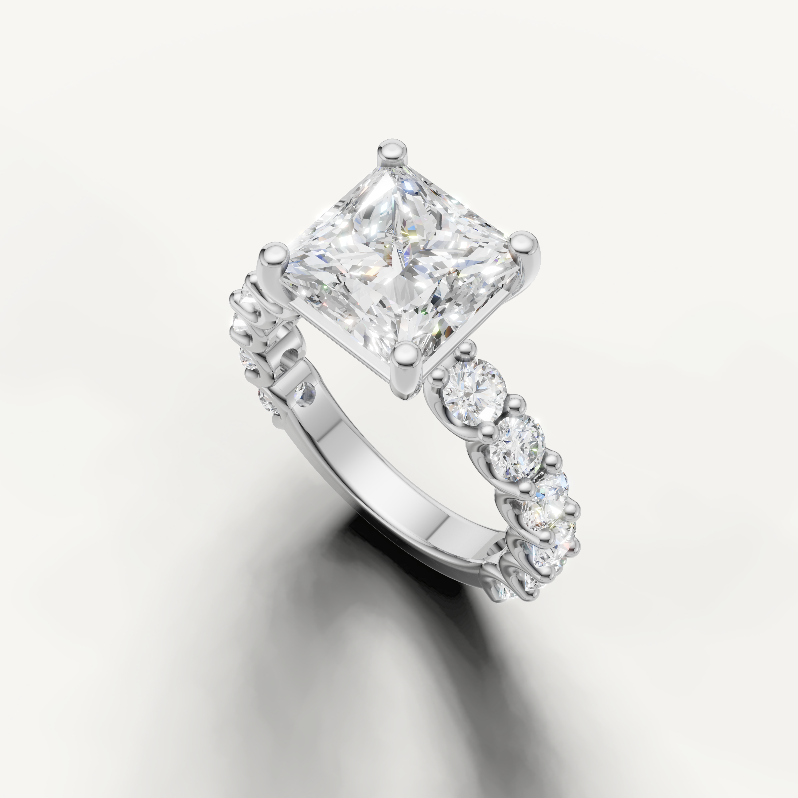 Square princess cut diamond ring with graduated side stones shared prong setting white gold