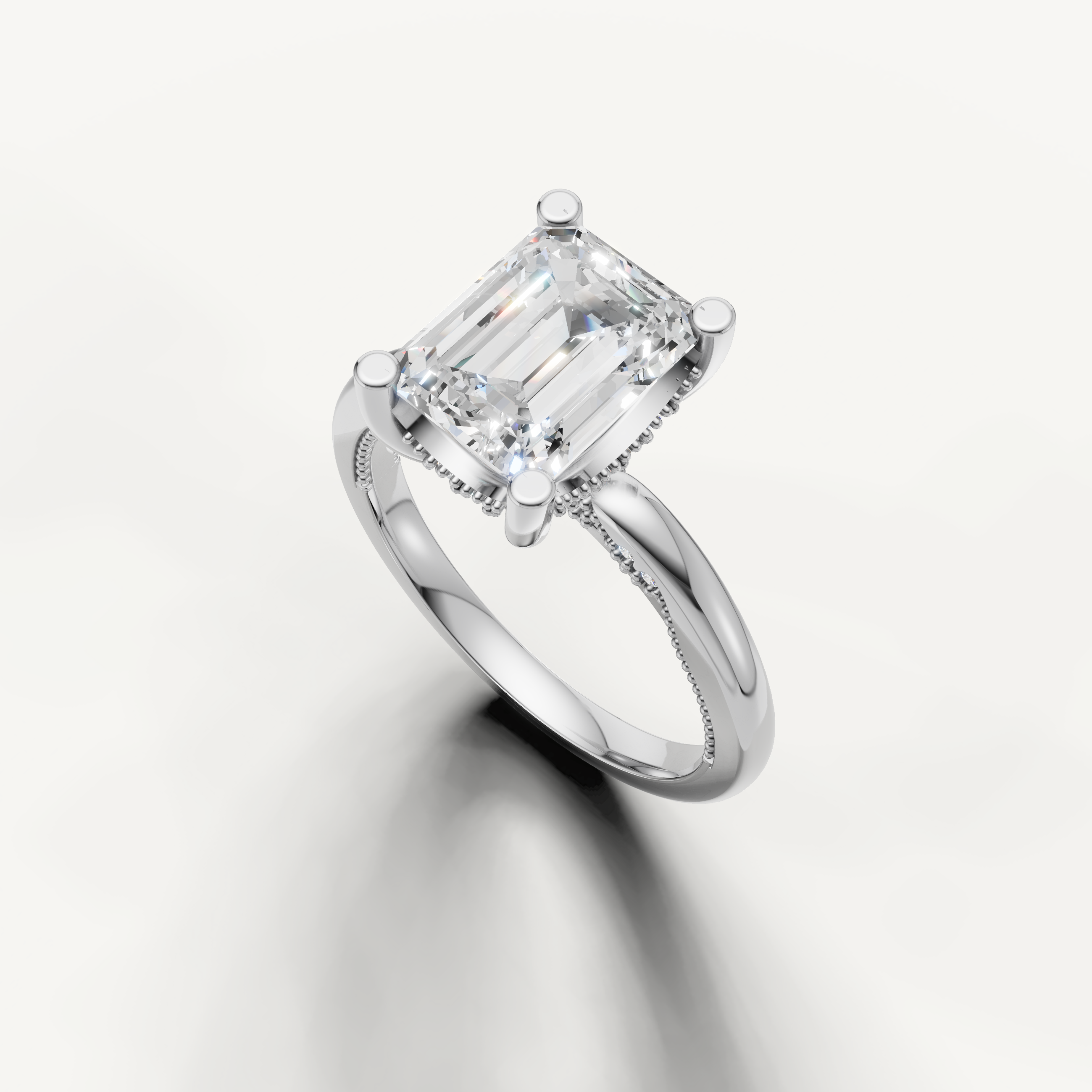 A high-polish white metal solitaire ring showcasing the sharp, sophisticated lines of a large emerald-cut diamond.