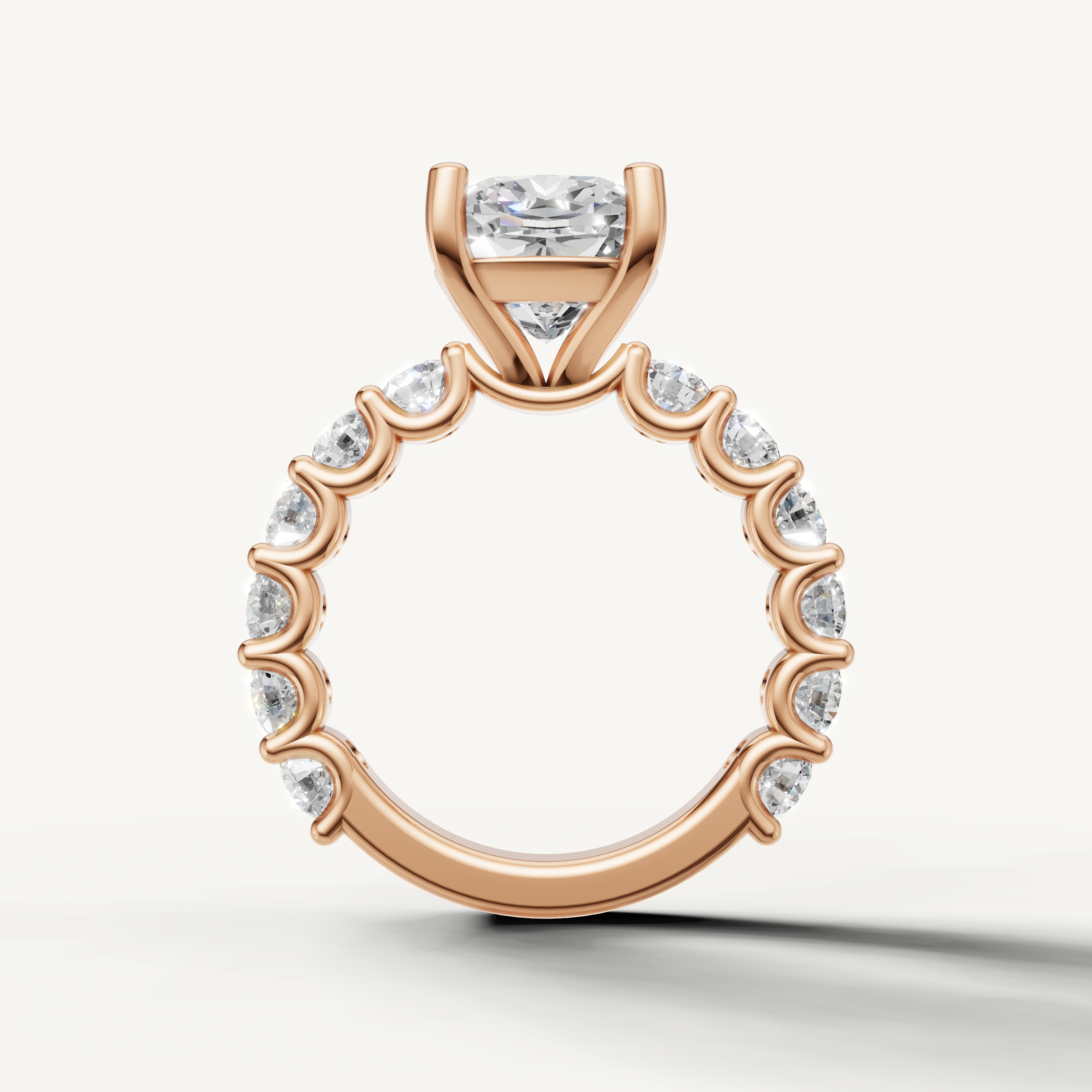 Cushion engagement ring with open gallery shared prong band rose gold