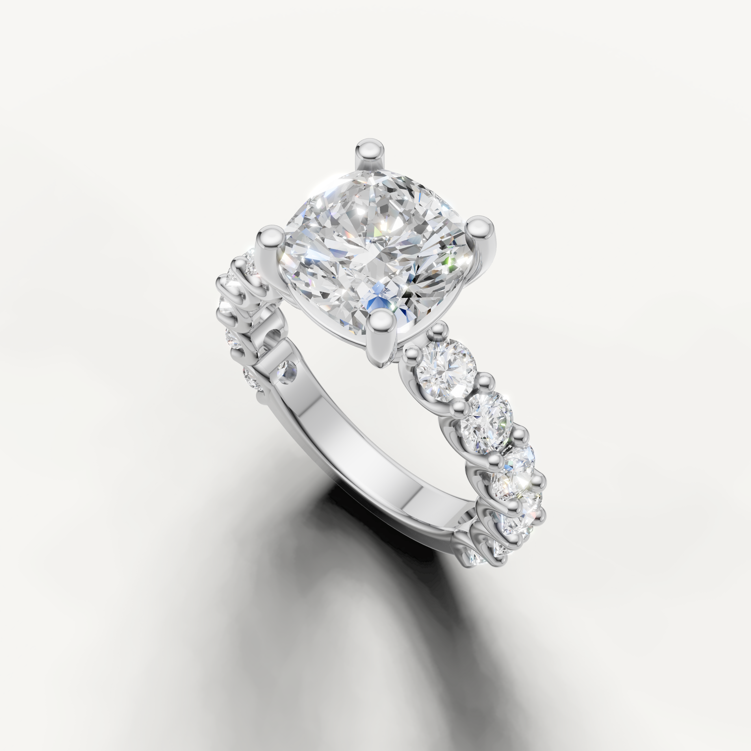 Cushion cut diamond ring with side stones shared prong setting white gold