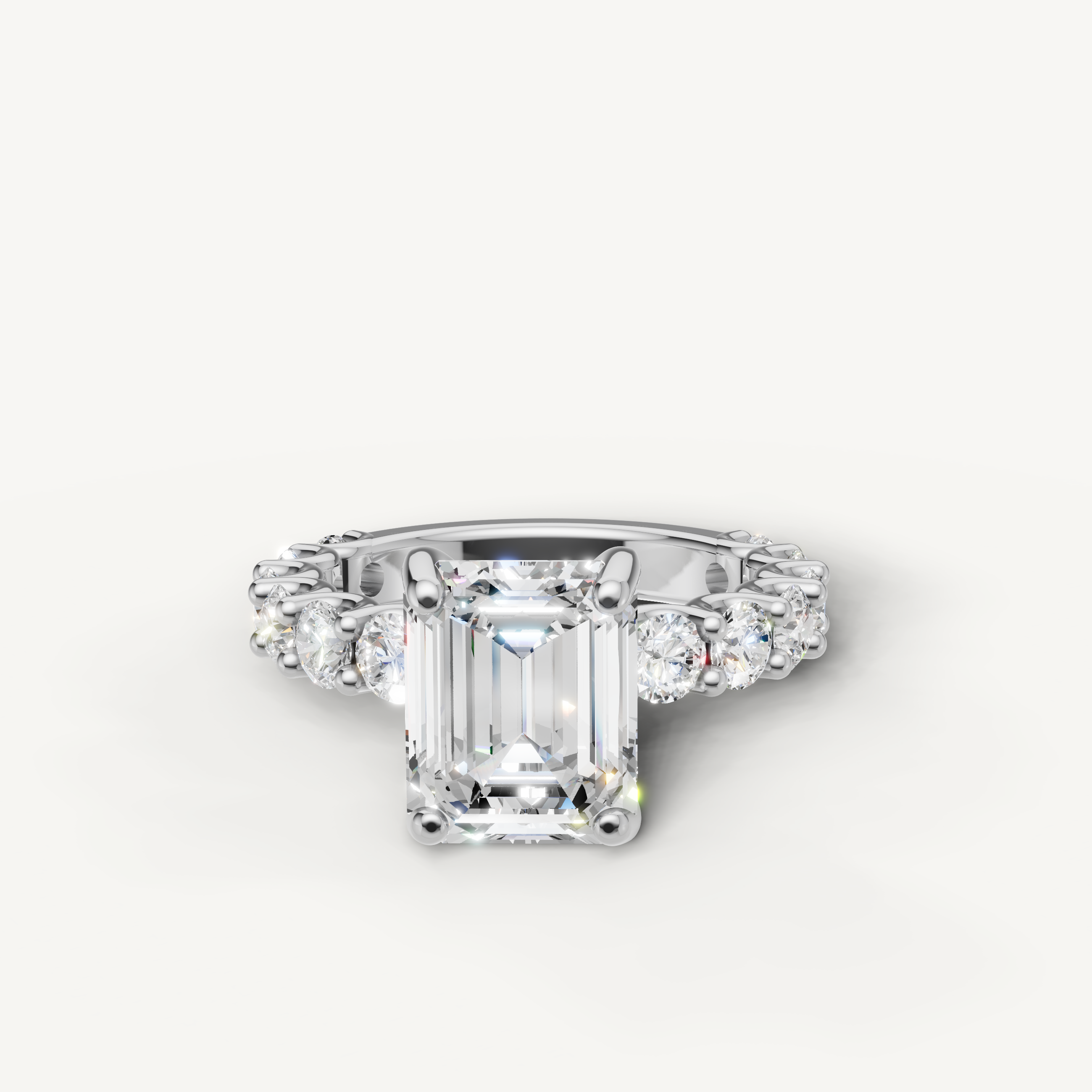 Emerald cut lab grown diamond engagement ring with shared prong side stones in 14K white gold