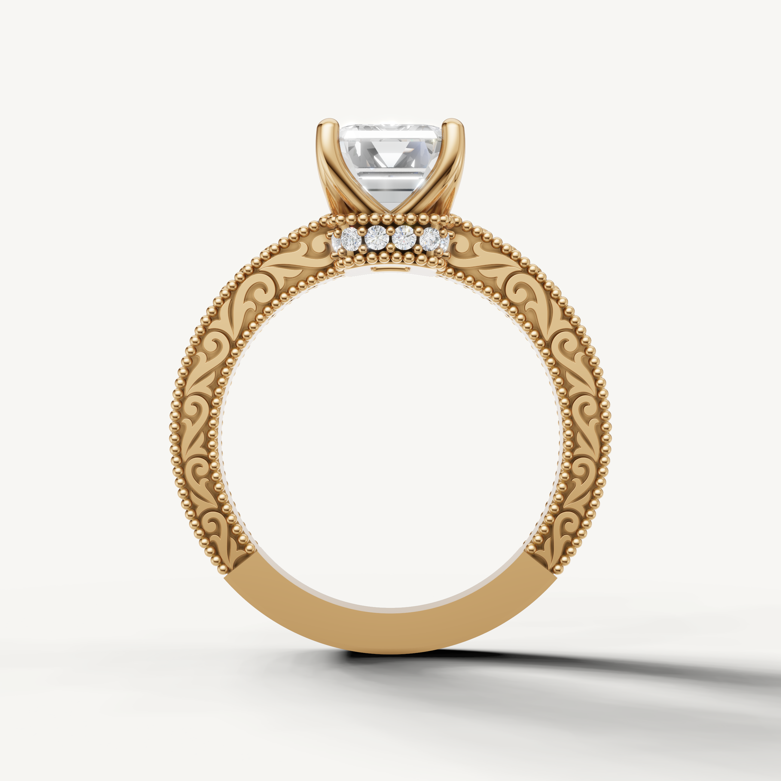 Antique-inspired emerald cut lab grown diamond engagement ring in 14K yellow gold with ornate floral filigree by Raul Diamonds.
