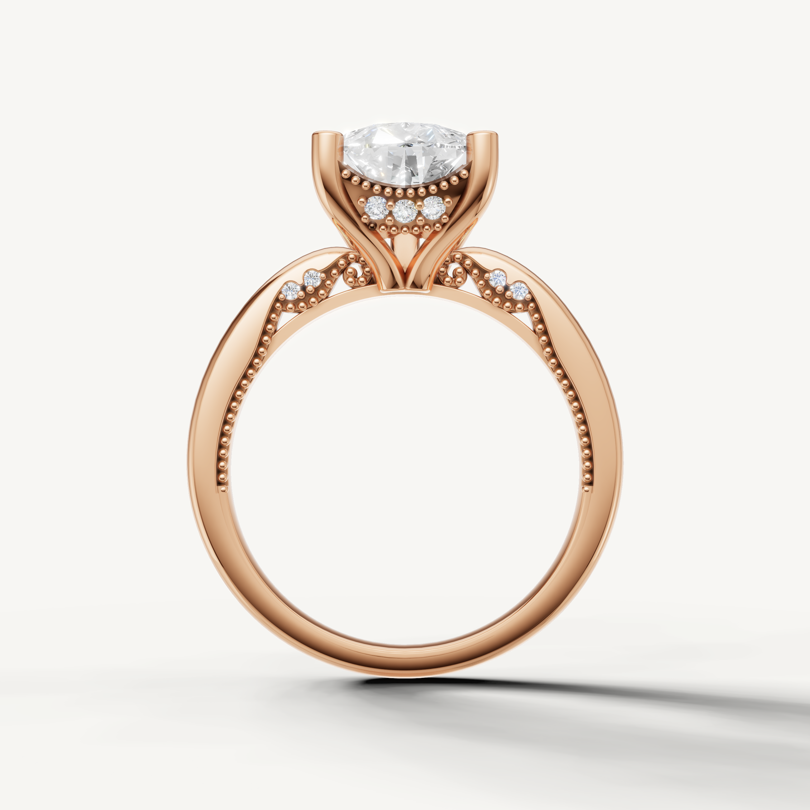 A sophisticated rose gold engagement ring that beautifully frames the clarity and graceful geometry of a pear-cut center diamond.