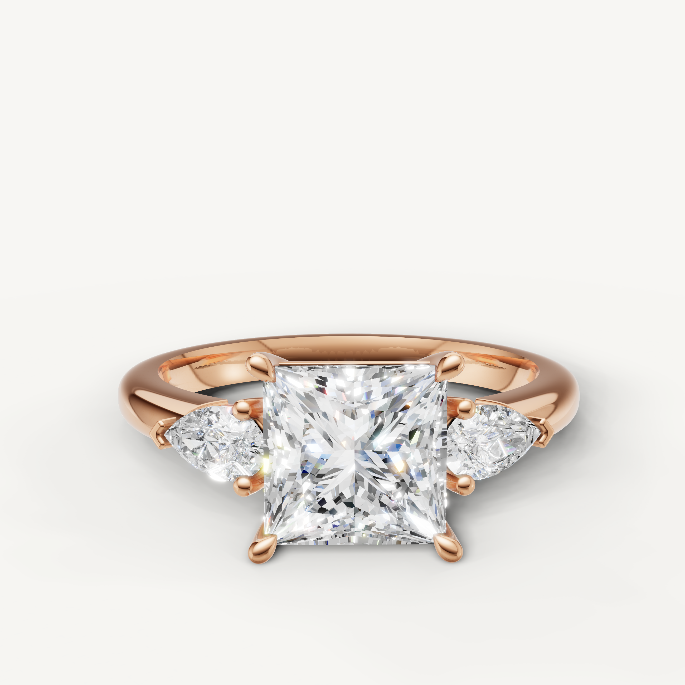 princess cut lab grown diamond engagement ring with pear side stones in 14k rose gold