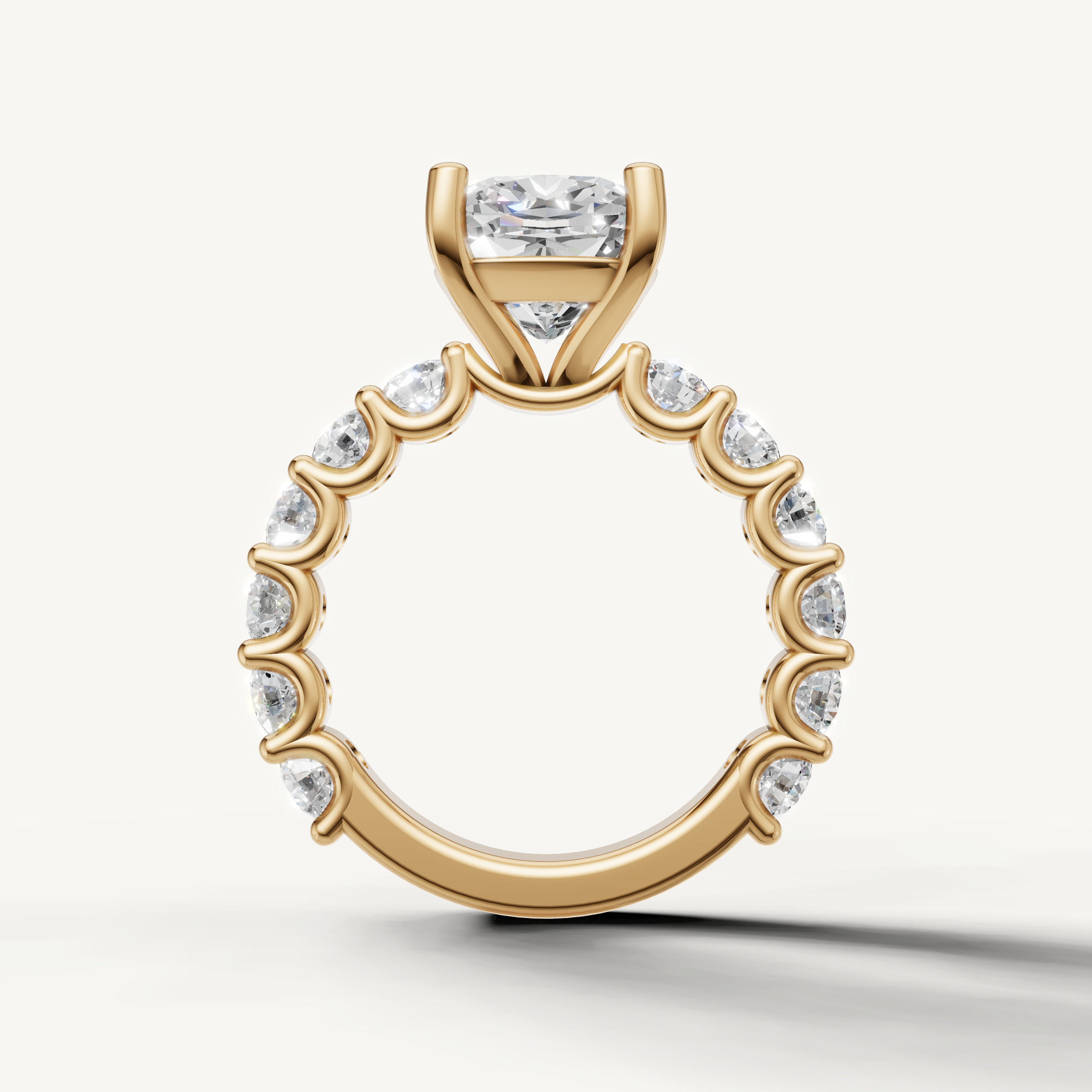 Elegant cushion diamond engagement ring with open gallery shared prong band yellow gold
