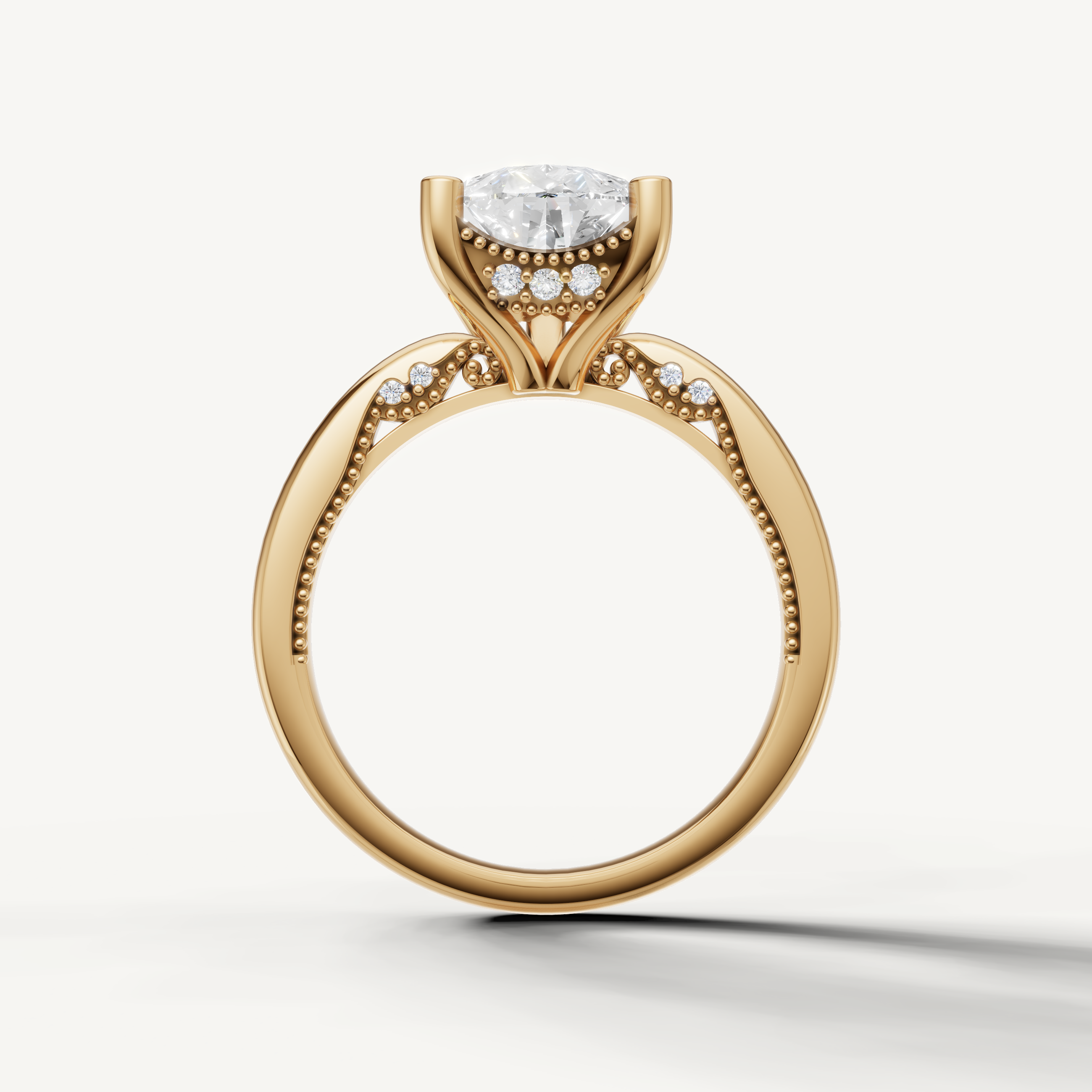 A sleek, contemporary yellow gold solitaire ring that focuses attention on the radiant, multi-faceted pear-cut diamond.