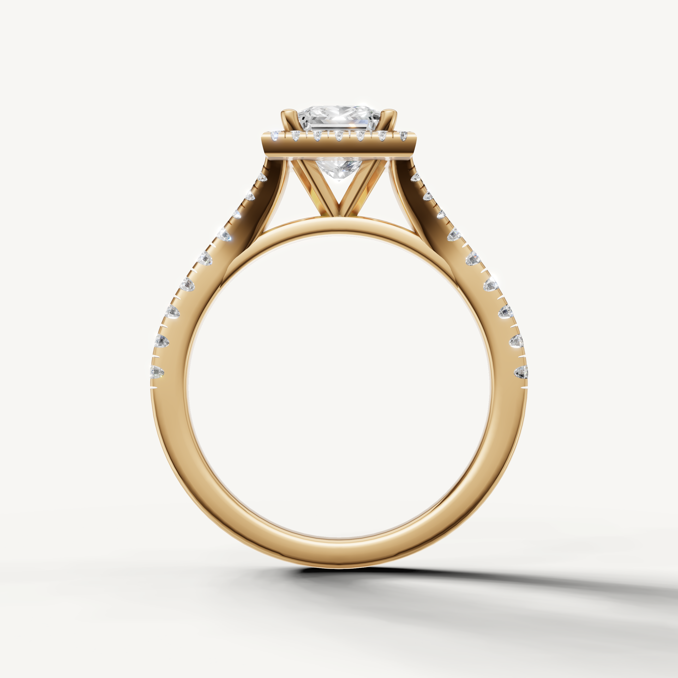 Elegant princess cut halo engagement ring with pavé diamonds yellow gold