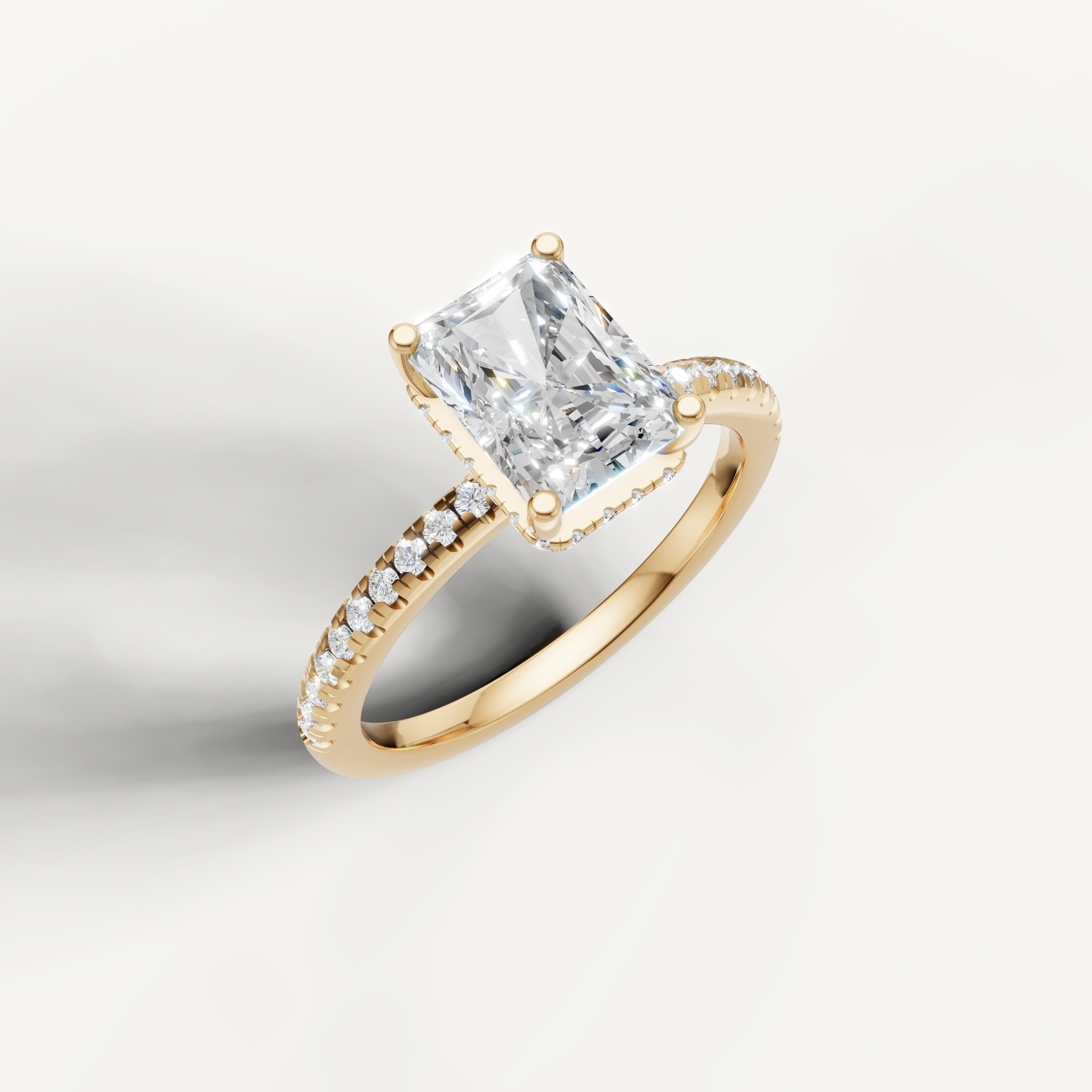 IGI certified radiant cut lab diamond solitaire ring with delicate pavé shank yellow gold