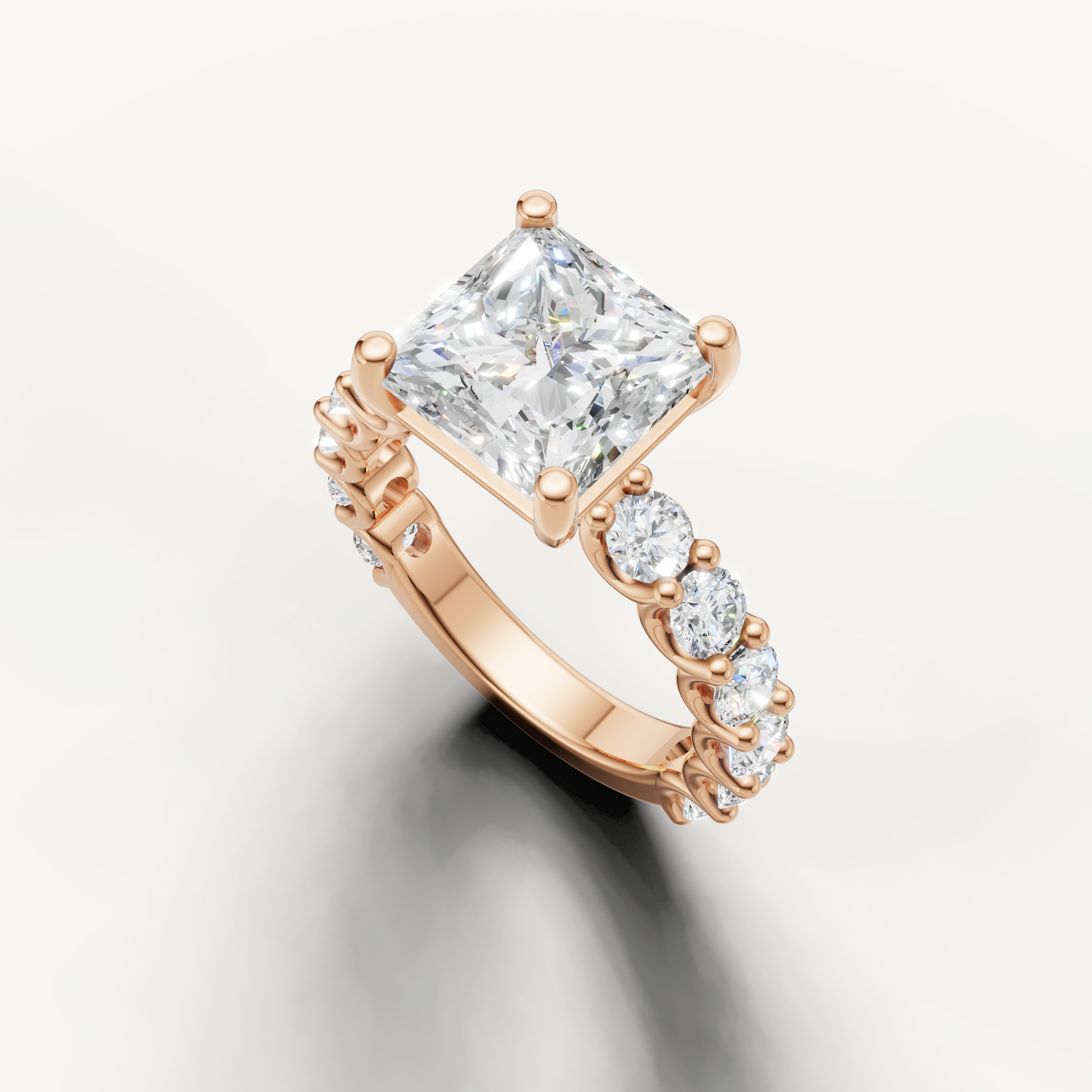 Square princess cut diamond ring with graduated side stones in rose gold