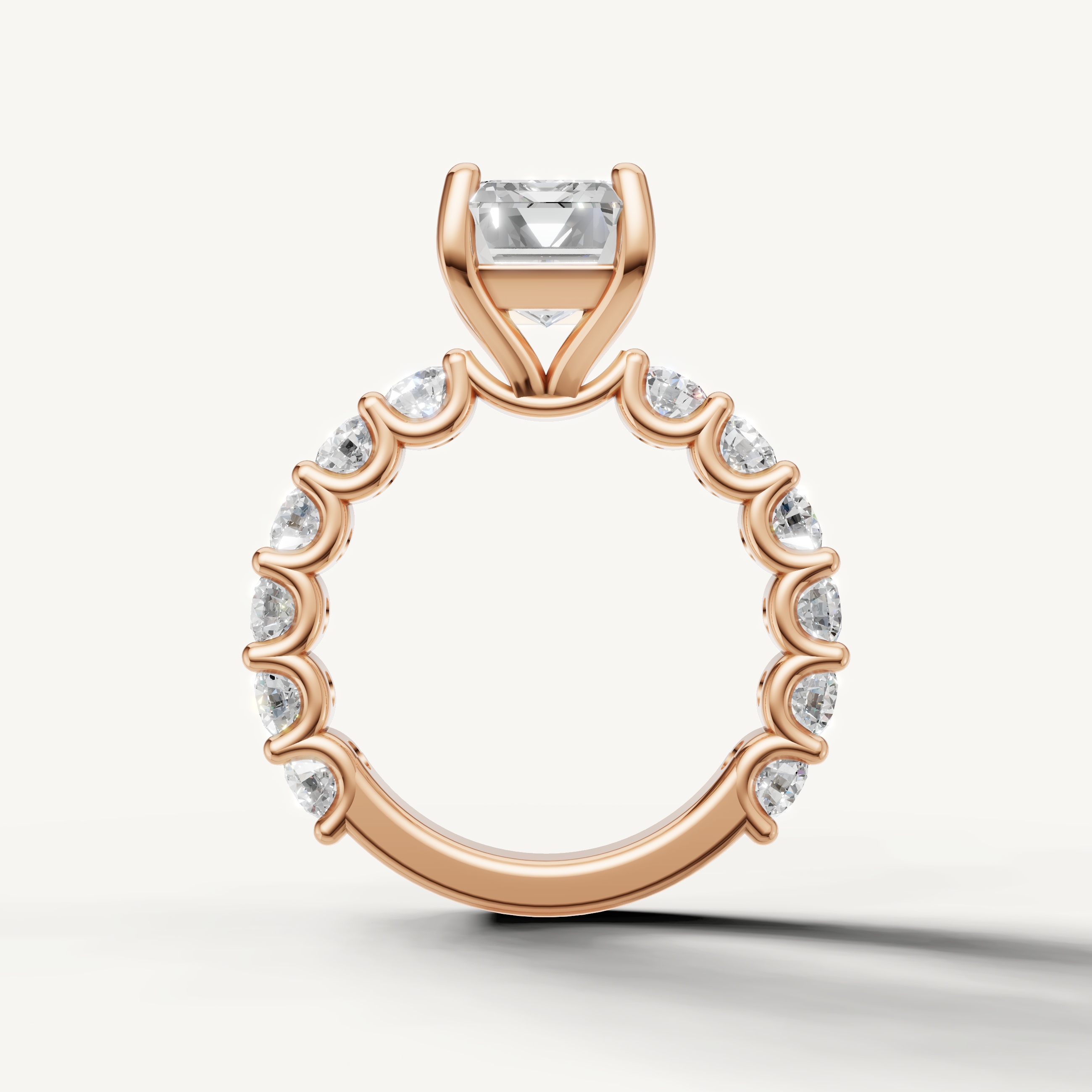 Emerald engagement ring with open gallery shared prong band rose gold