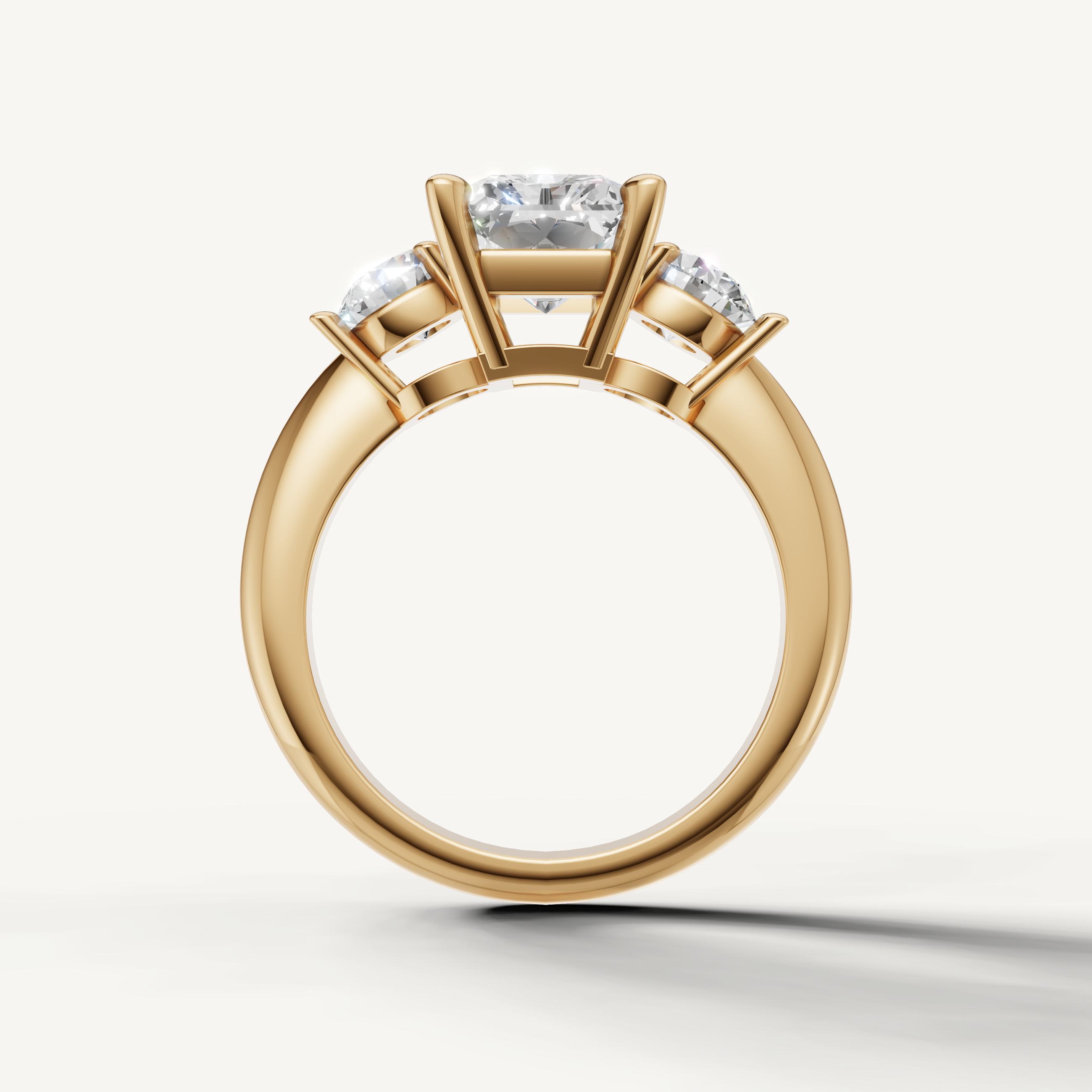 Radiant diamond engagement ring with round side stones yellow gold