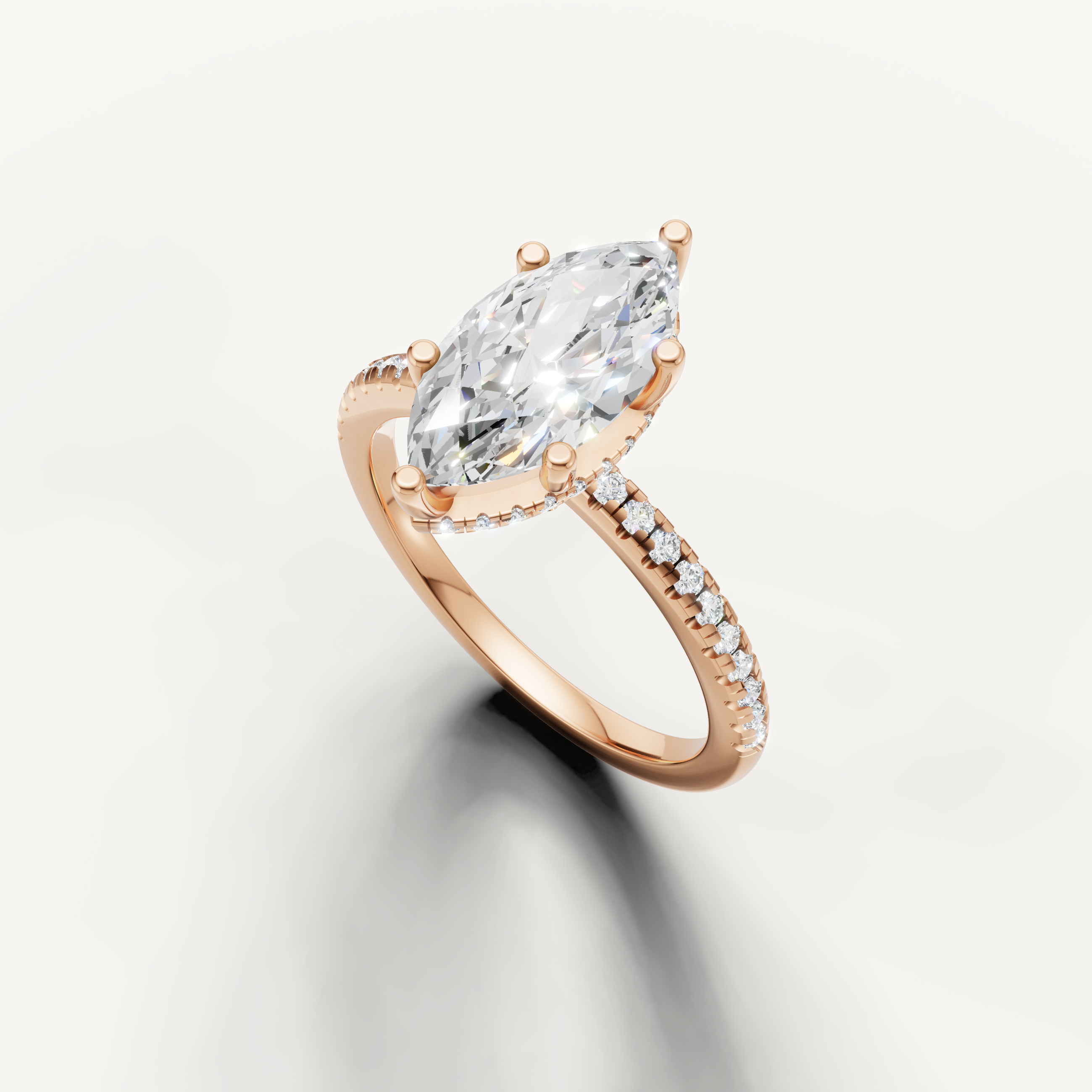 elongated marquise diamond engagement ring with delicate pavé setting in rose gold