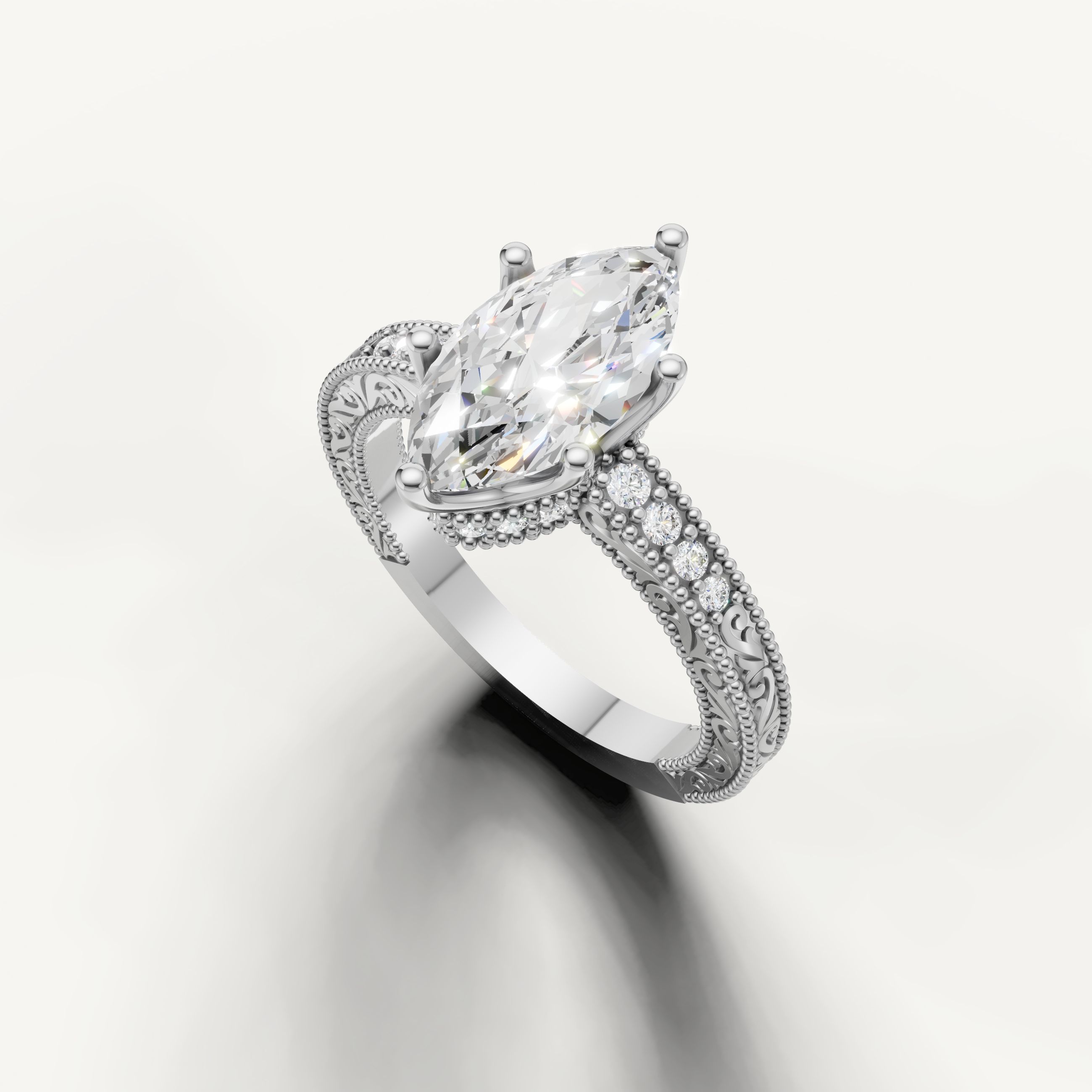 Elegant marquise diamond engagement ring in white gold with vintage floral engraving and pavé detailing by Raul Diamonds.