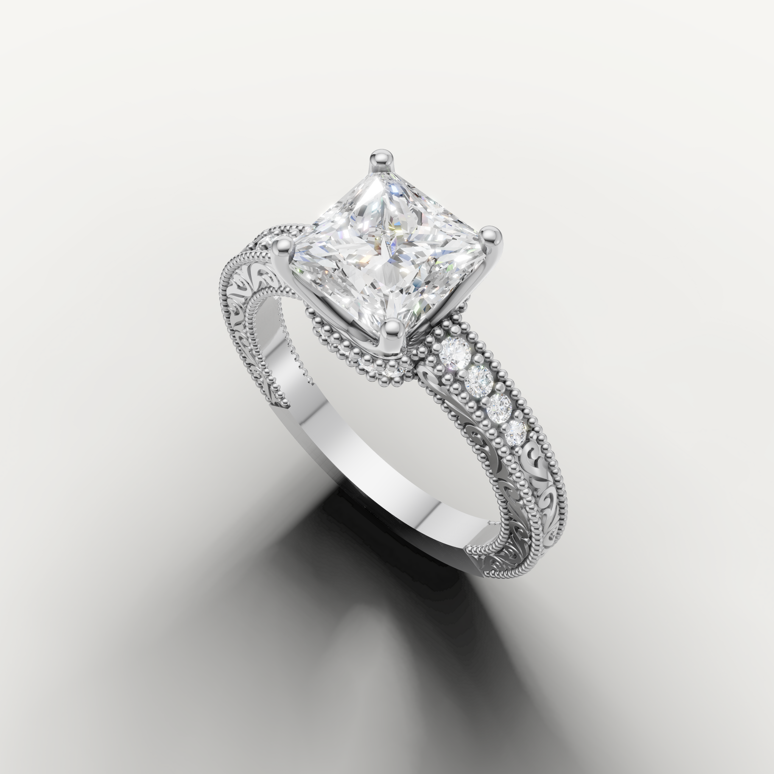 Elegant princess diamond engagement ring in white gold with vintage floral engraving and pavé detailing by Raul Diamonds.