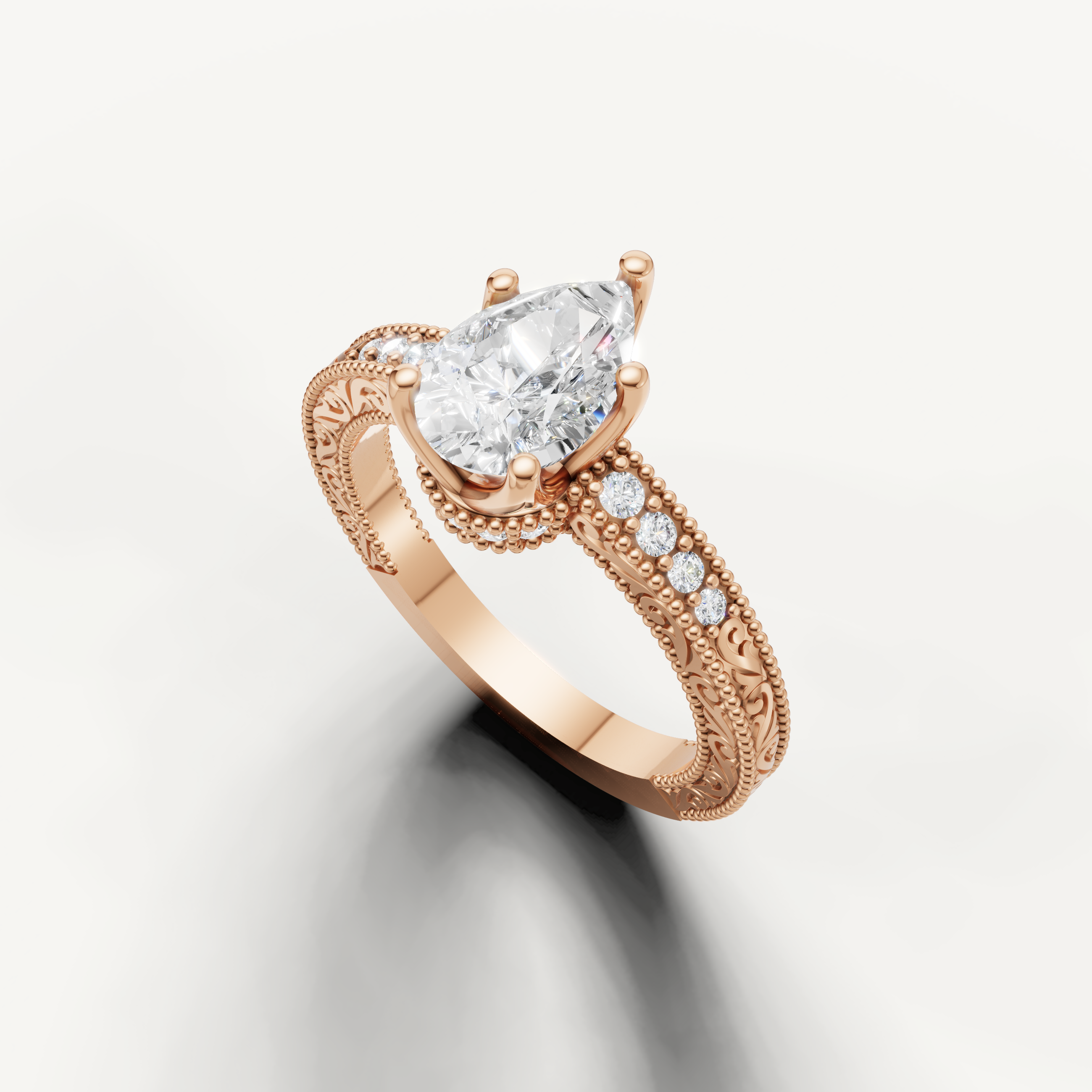 Vintage-inspired pear diamond engagement ring with decorative pavé band in 14K rose gold from Raul Diamonds.
