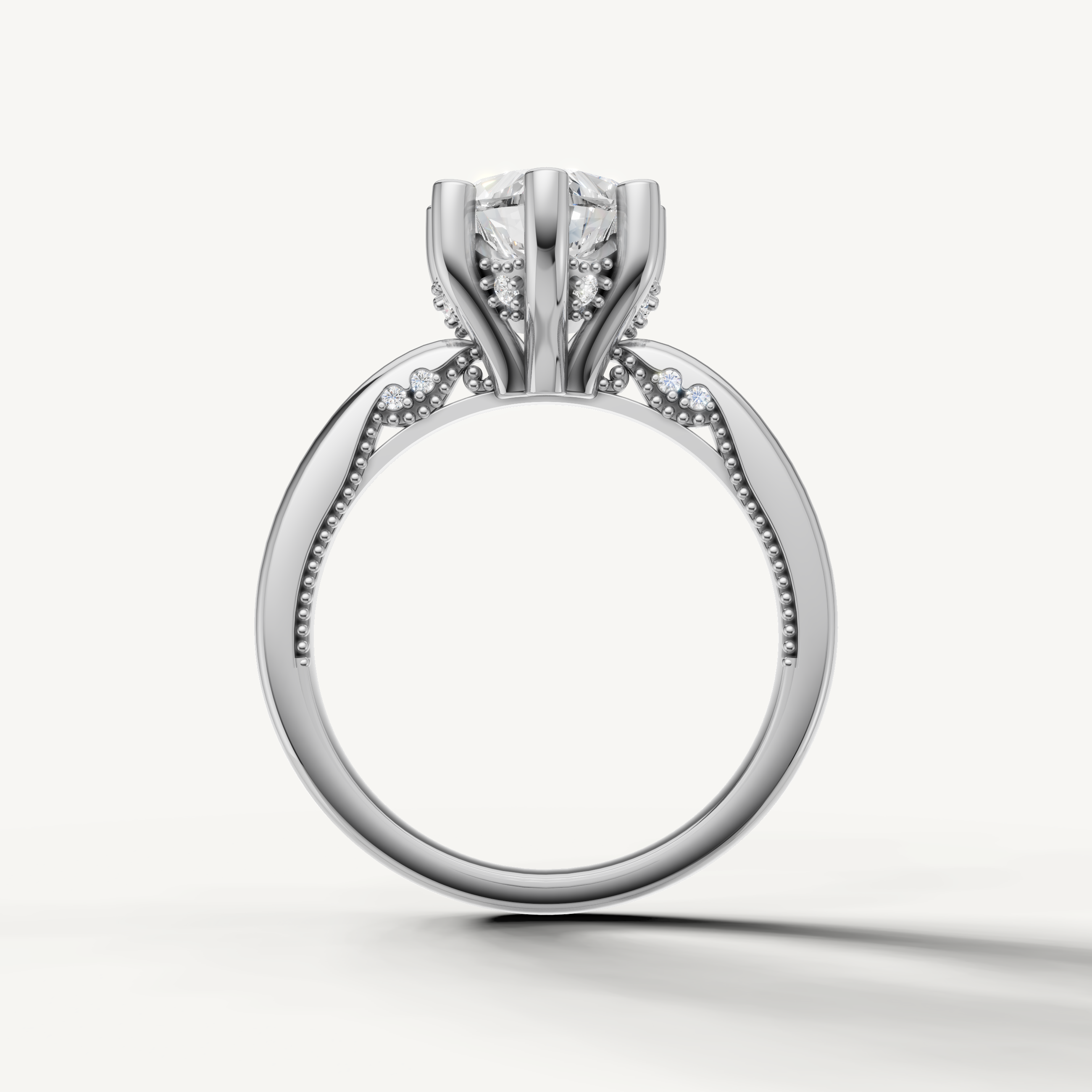 A luxury white gold engagement ring that maximizes the brilliance and fire of a central heart-cut diamond against a cool, bright metal finish.