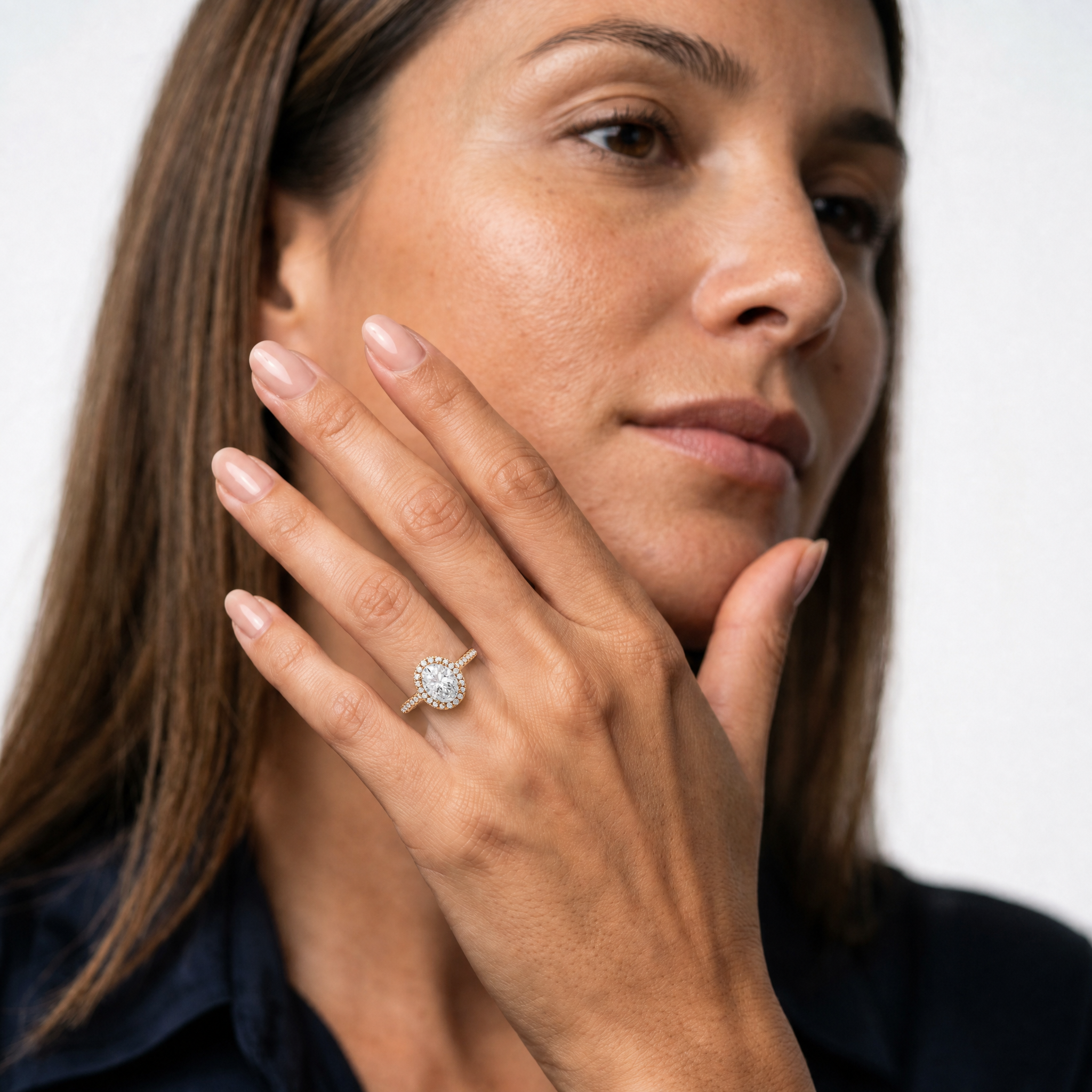 model-wearing-oval-cut-lab-grown-diamond-halo-engagement-ring