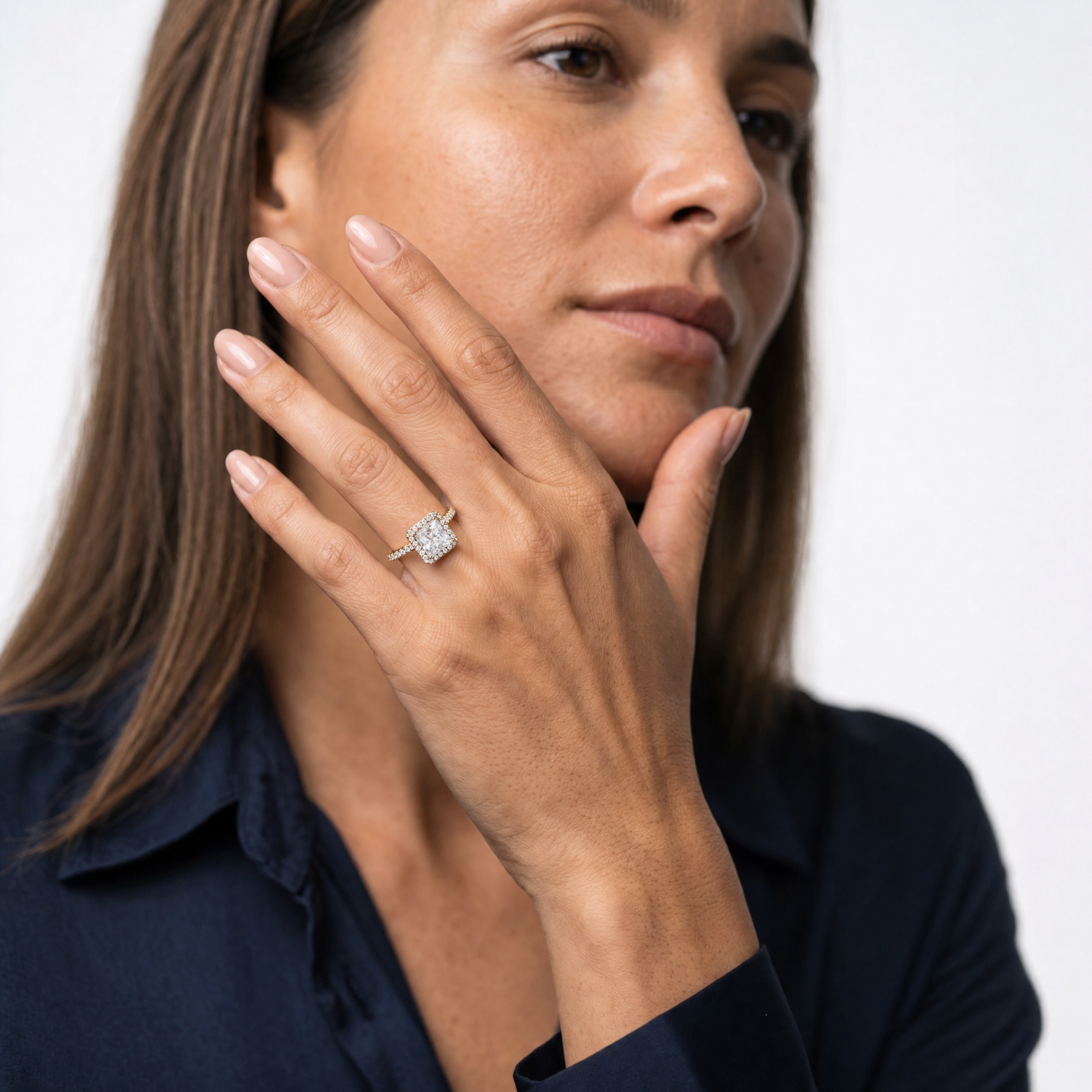 Model wearing a princess cut lab grown diamond halo engagement ring in 14K gold by Raul Diamonds