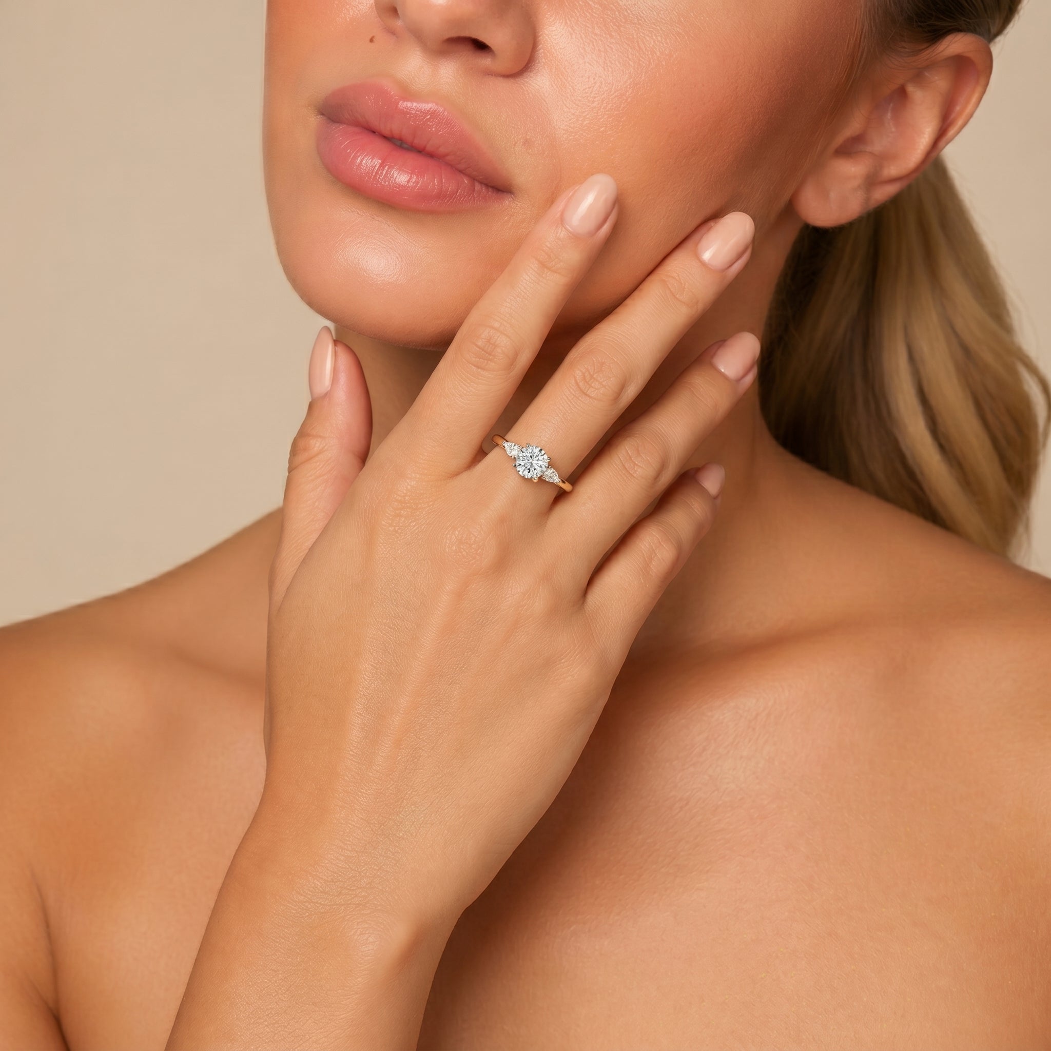 Close-up shot of a model's hand featuring the Raul Diamonds classic Round brilliant cut three-stone diamond ring.