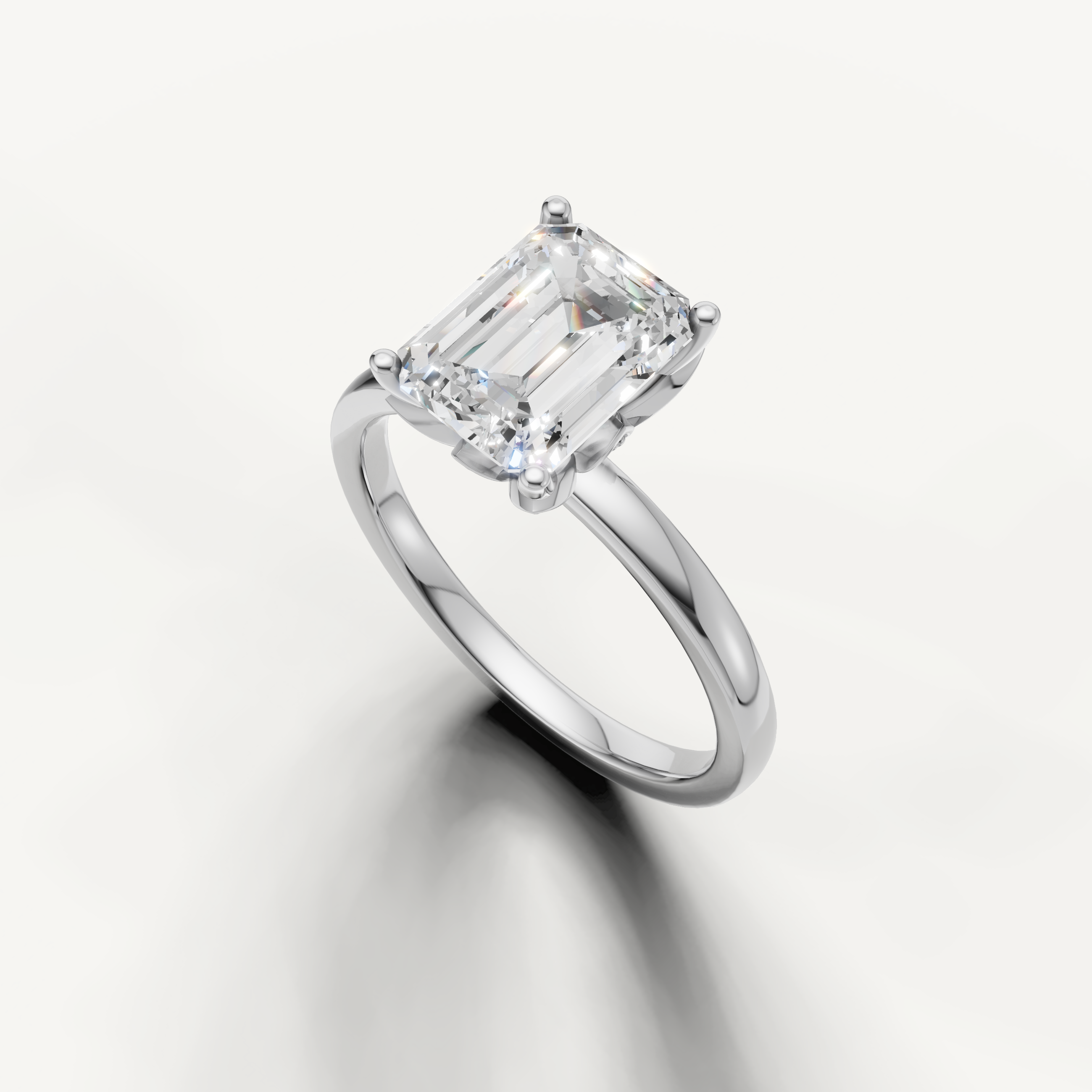 Elegant emerald cut solitaire ring with classic 4 prong setting white gold