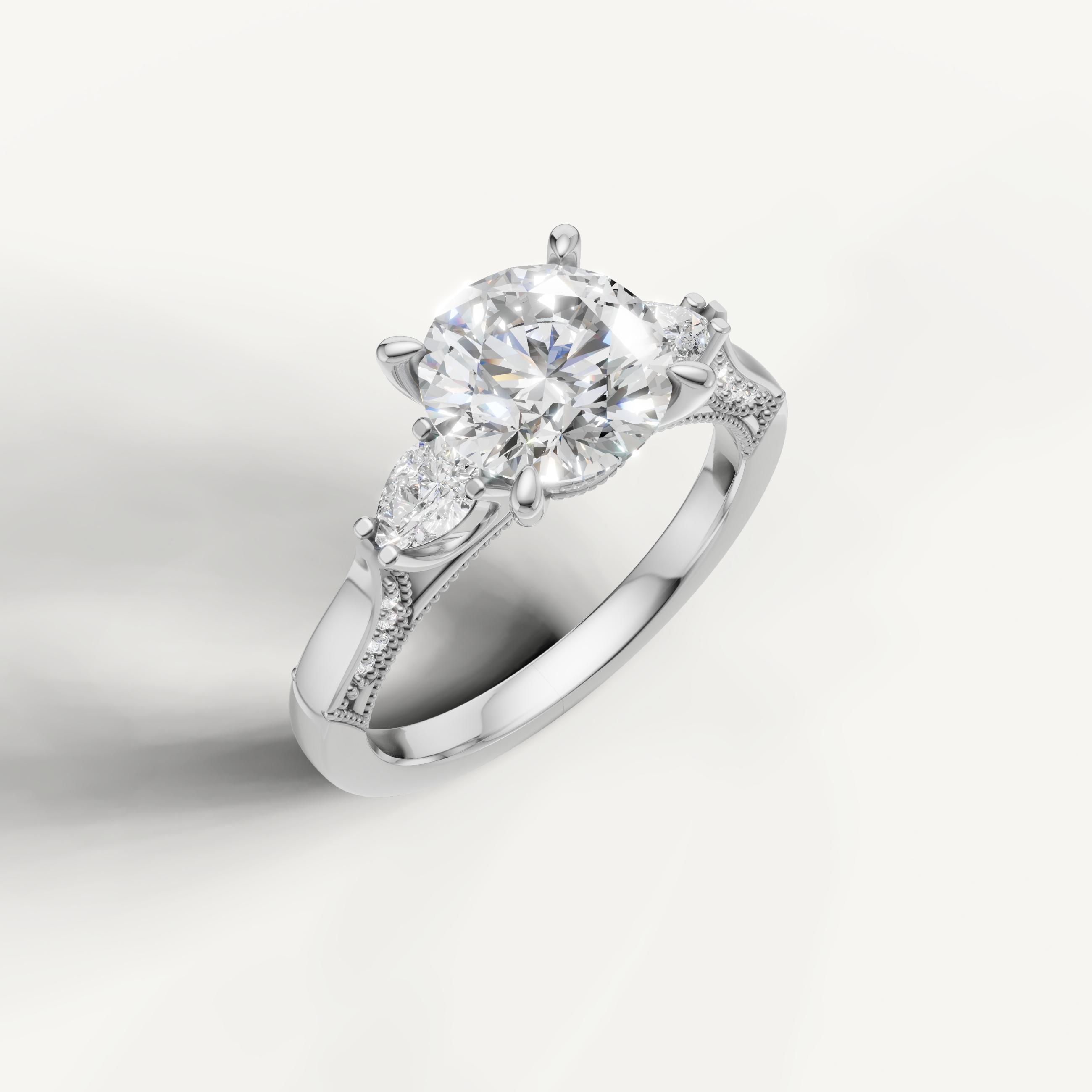 Round brilliant diamond ring with pear side stones white gold elegant design