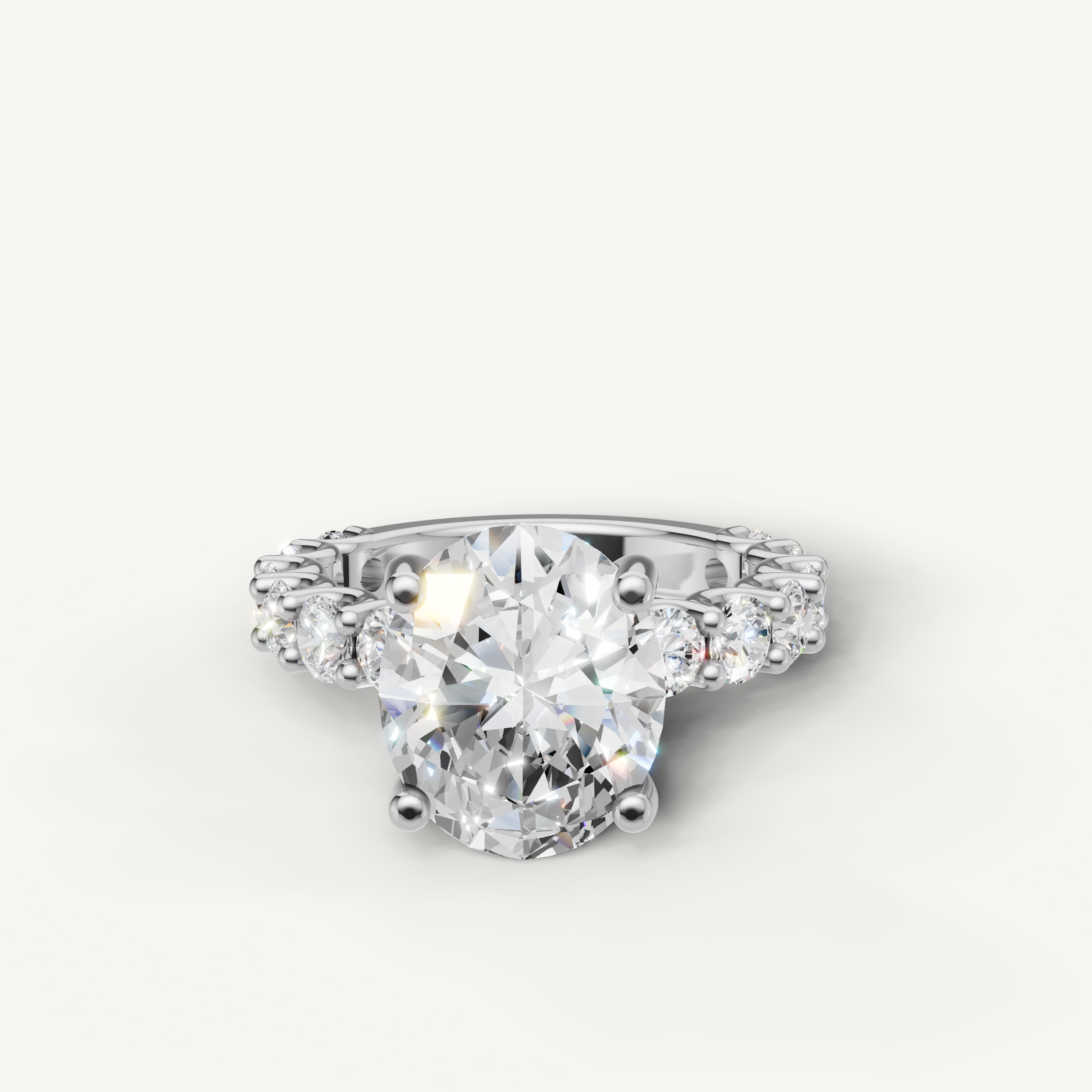 Oval cut lab grown diamond engagement ring with shared prong side stones in 14K white gold