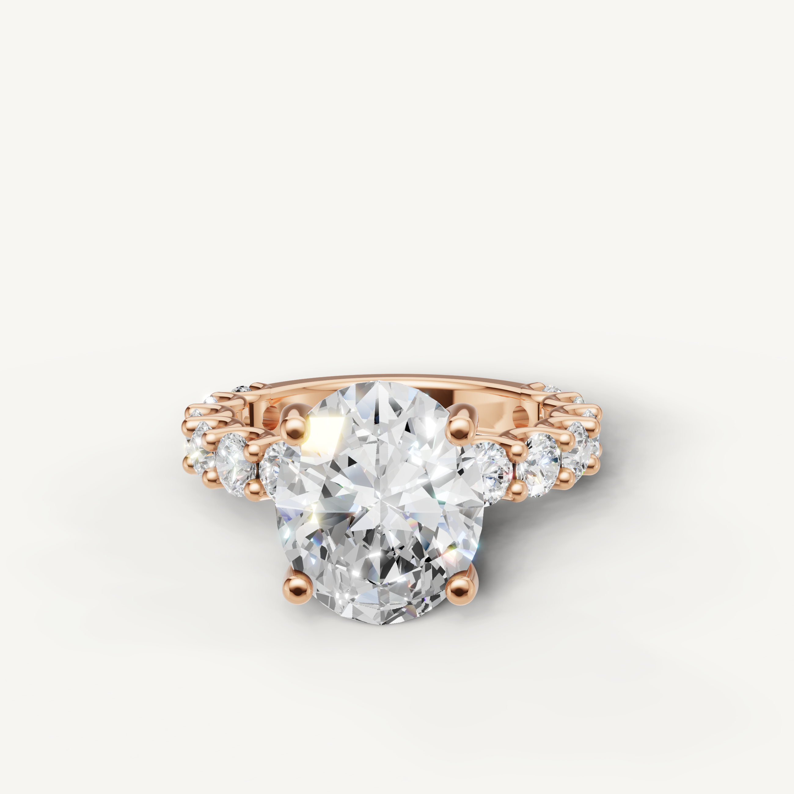 Oval cut lab grown diamond engagement ring with shared prong side stones in 14K rose gold