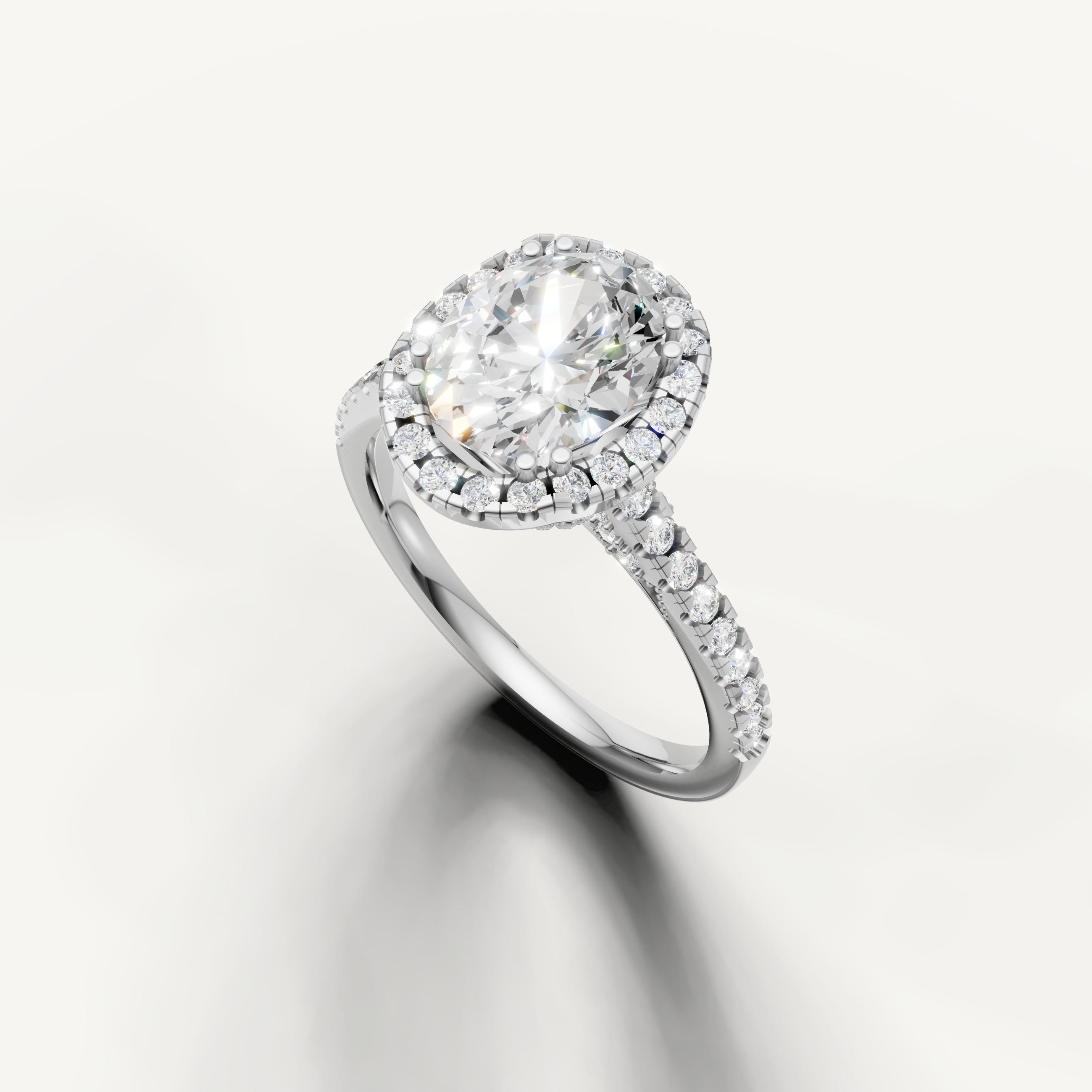White gold oval cut lab grown diamond ring featuring a timeless halo setting and sparkling pavé band