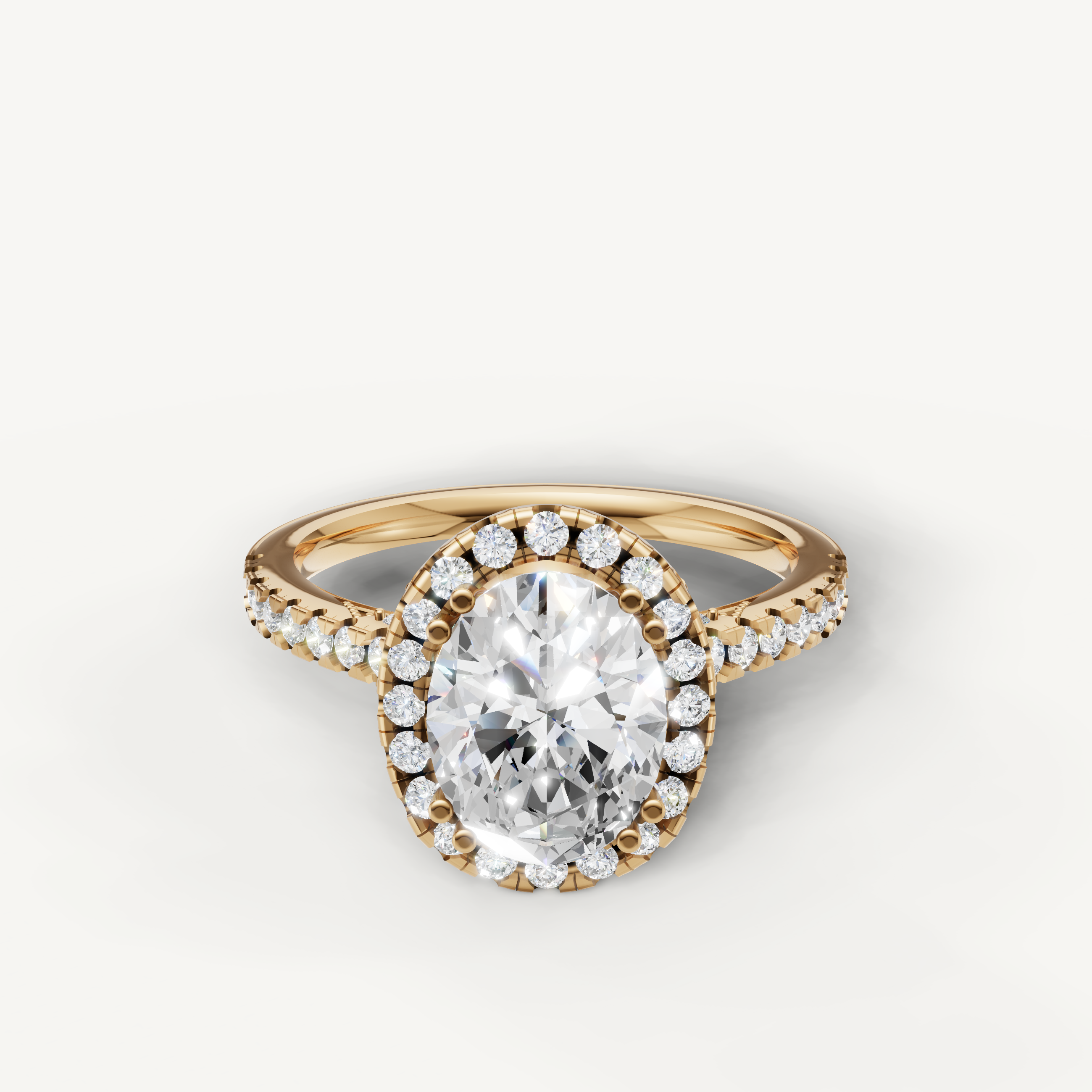Oval cut lab grown diamond halo engagement ring in 14K yellow gold with pavé diamond band by Raul Diamonds