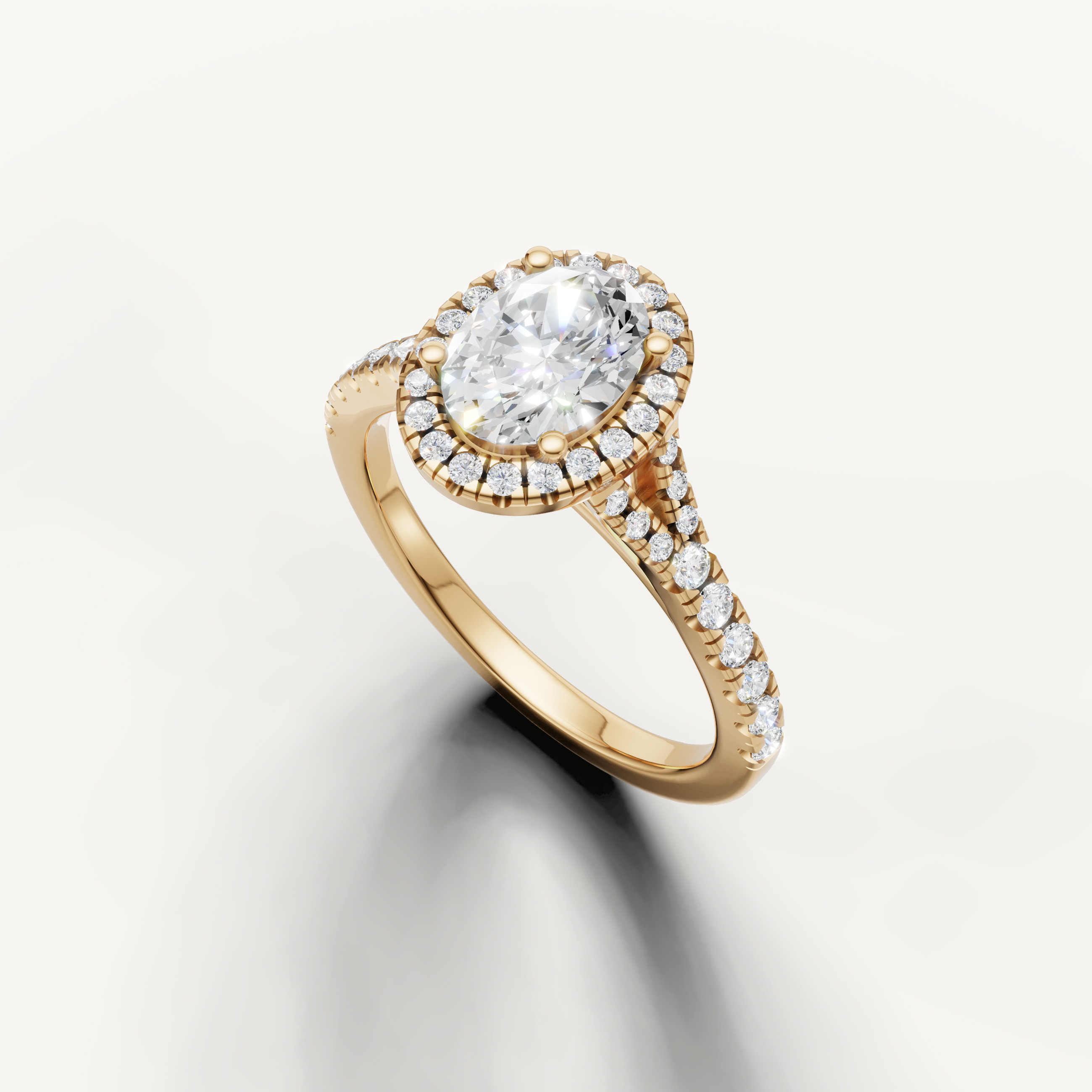 Oval diamond halo engagement ring with split pavé band yellow gold