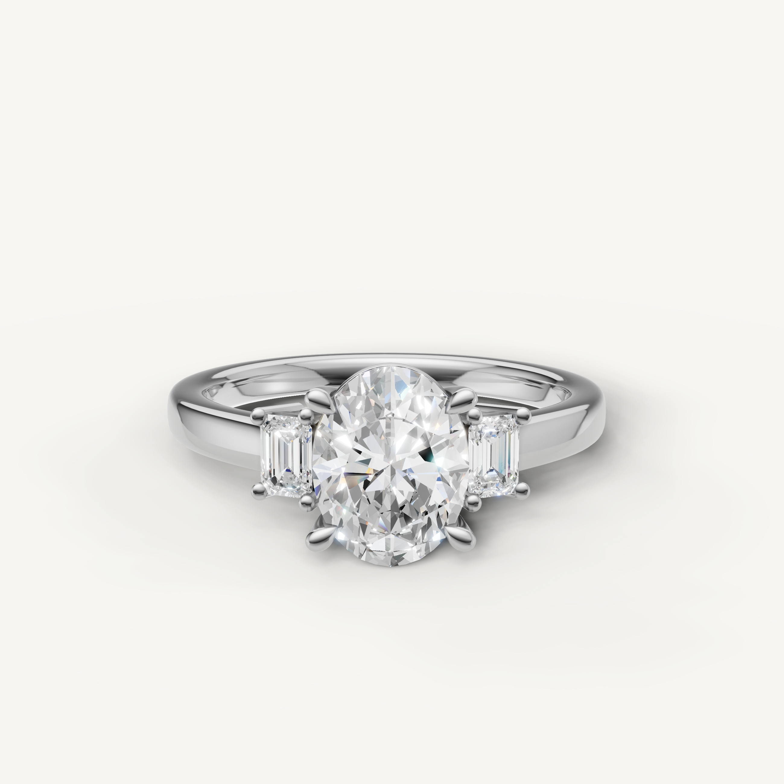 Oval cut lab grown diamond three stone engagement ring in 14K white gold with emerald cut side stones