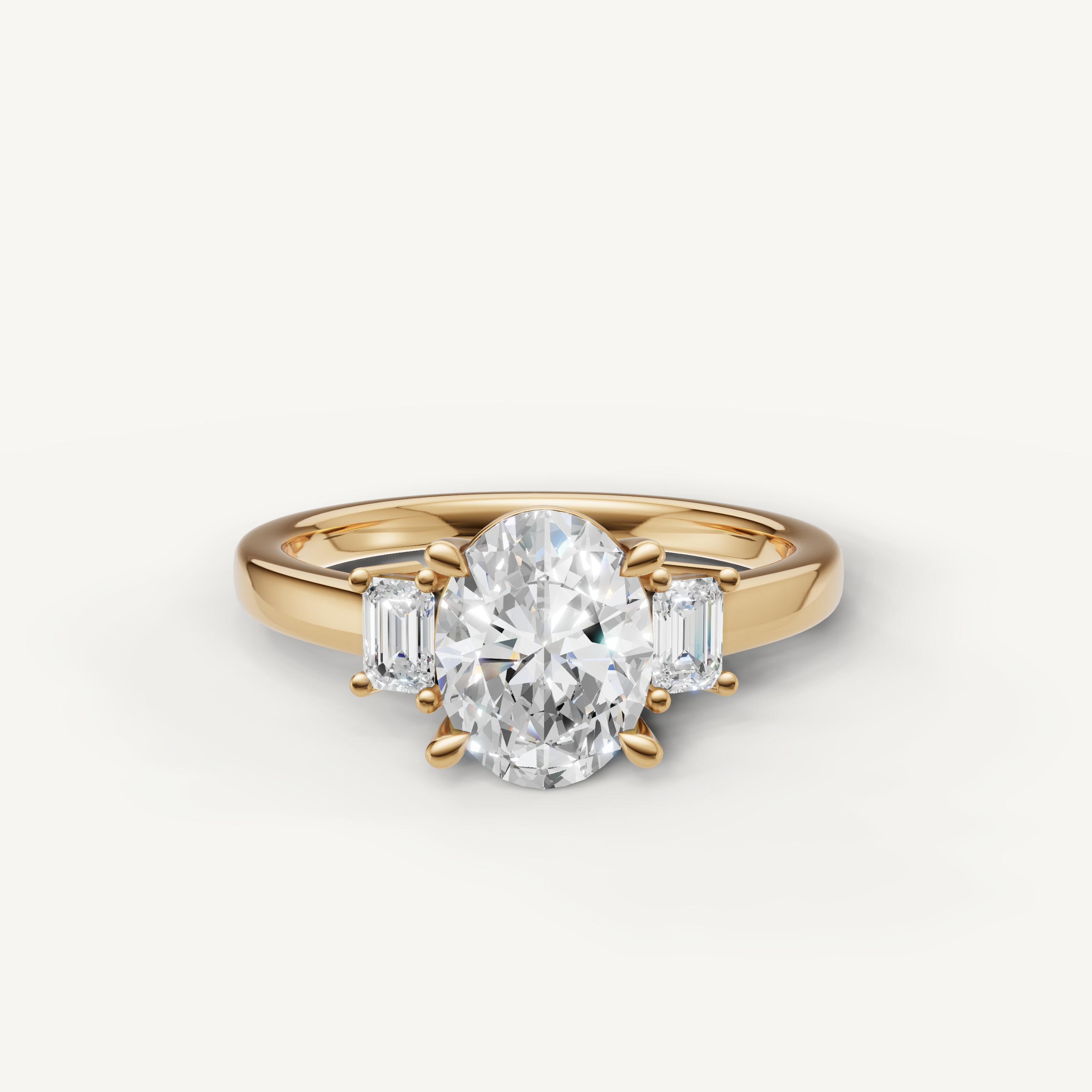Oval cut lab grown diamond three stone engagement ring in 14K yellow gold with emerald cut side stones