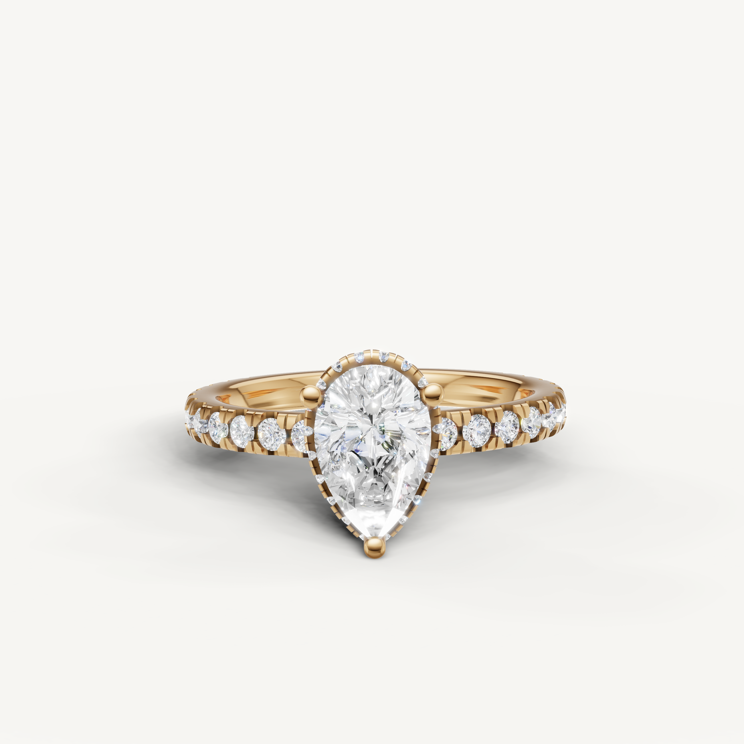 pear cut lab grown diamond hidden halo engagement ring in yellow gold with pavé diamond band and elegant teardrop silhouette