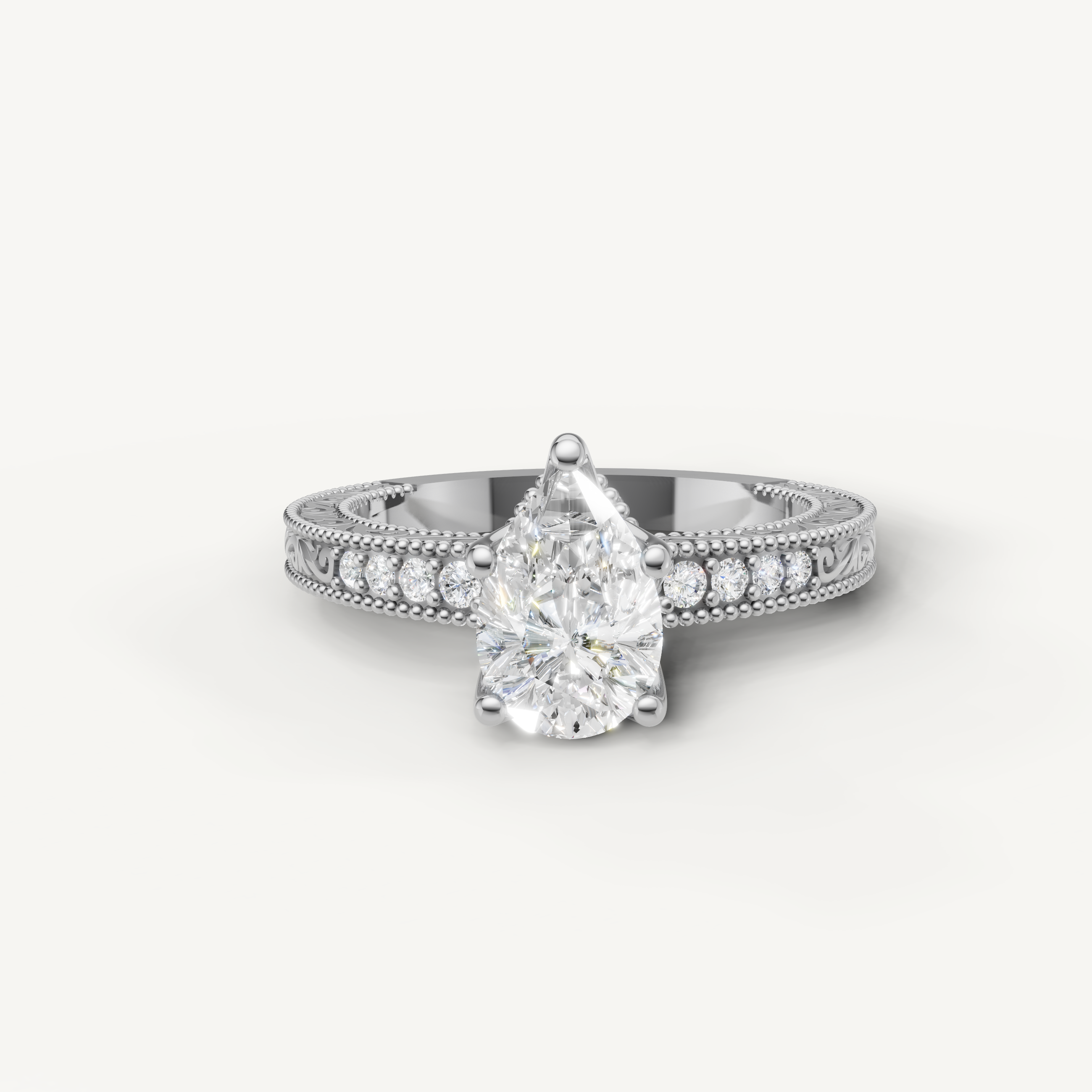 Vintage pear cut lab grown diamond engagement ring in 14K white gold with ornate milgrain and pavé accents by Raul Diamonds.