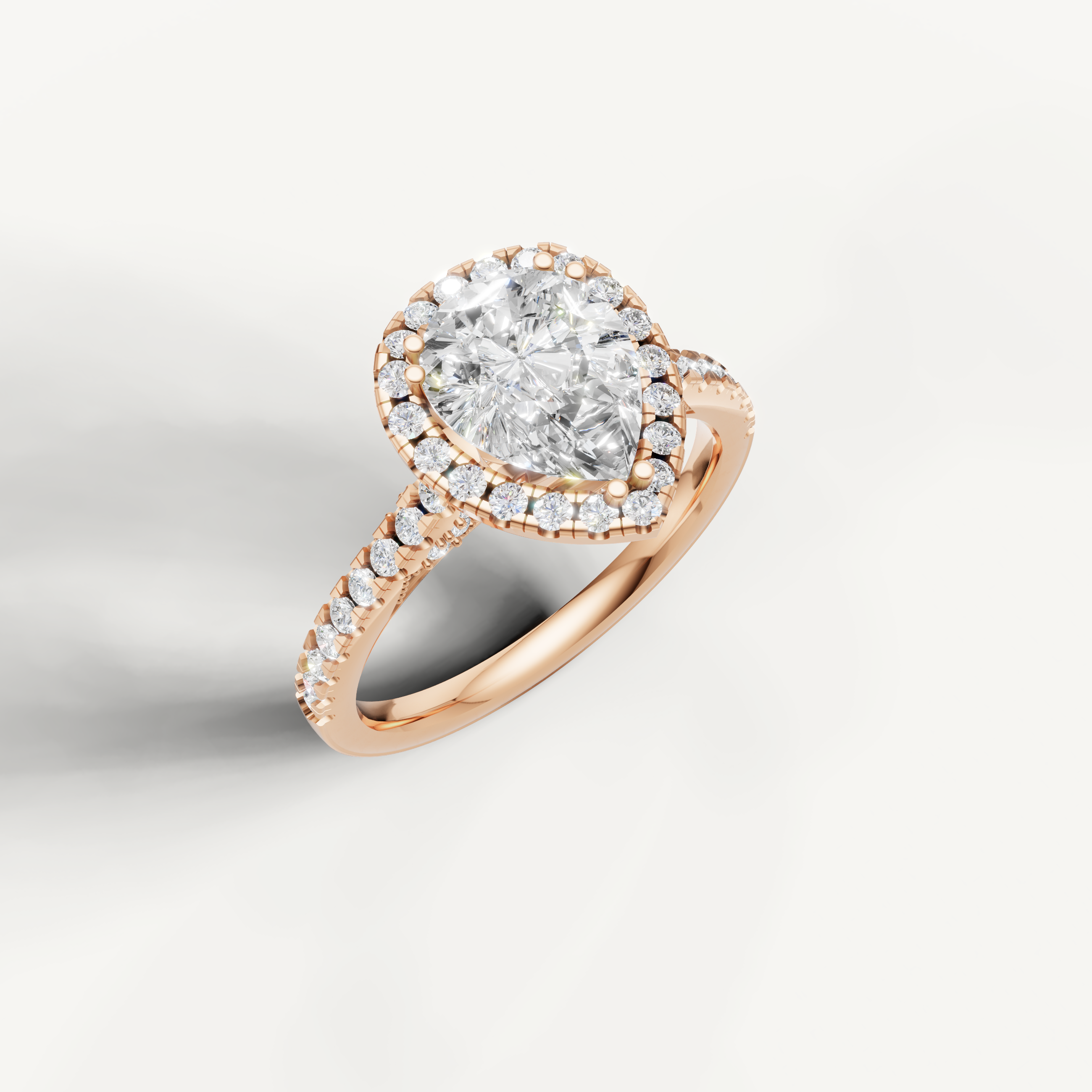 14K rose gold pear lab diamond engagement ring with sparkling halo and pavé shank from Raul Diamonds