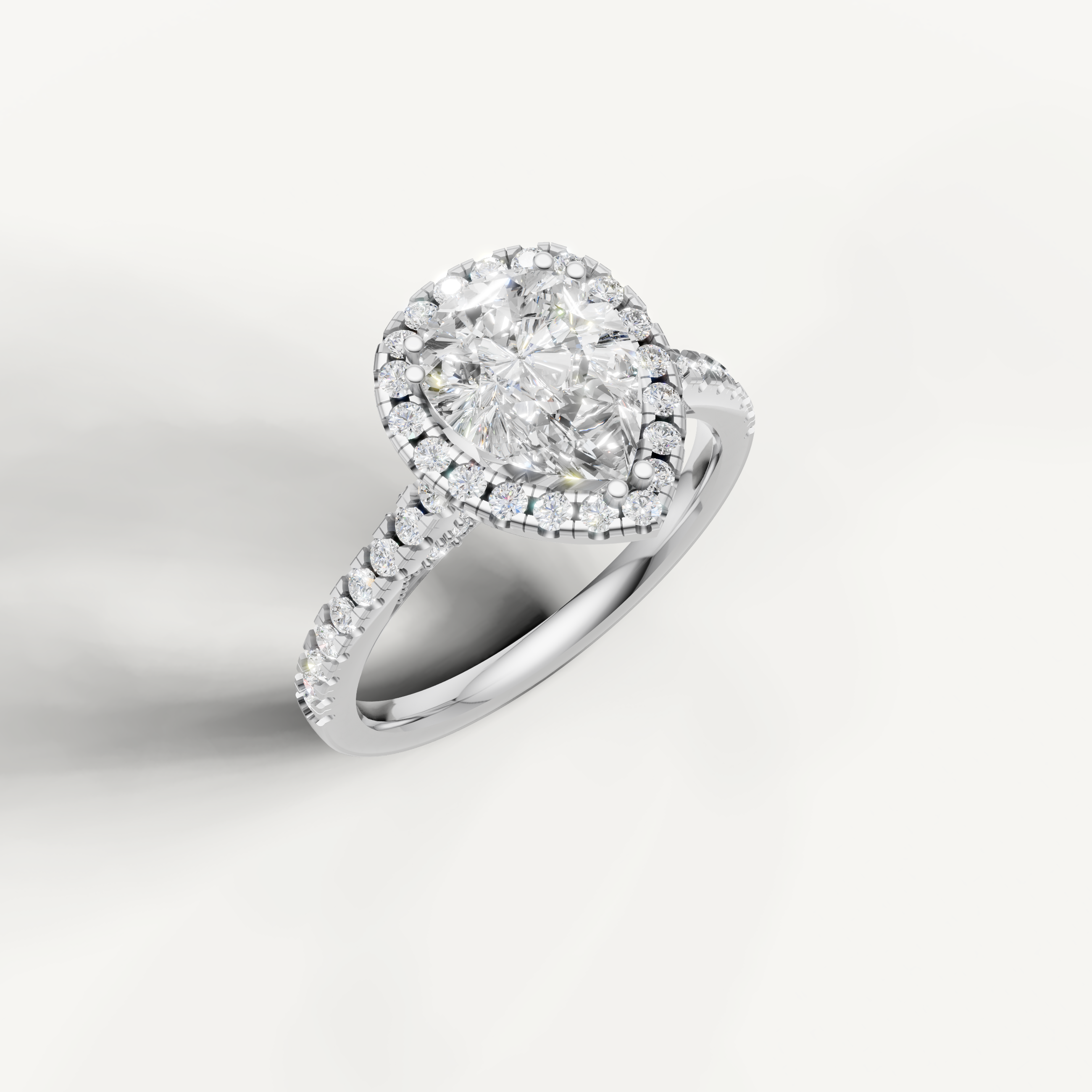 14K white gold pear lab diamond engagement ring with radiant halo and pavé shank from Raul Diamonds